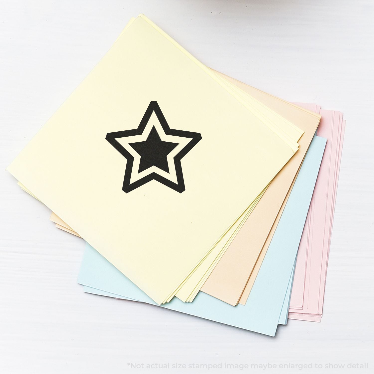 Stack of pastel colored paper sheets with a black star icon, decorative stationery and craft paper samples on a white background.