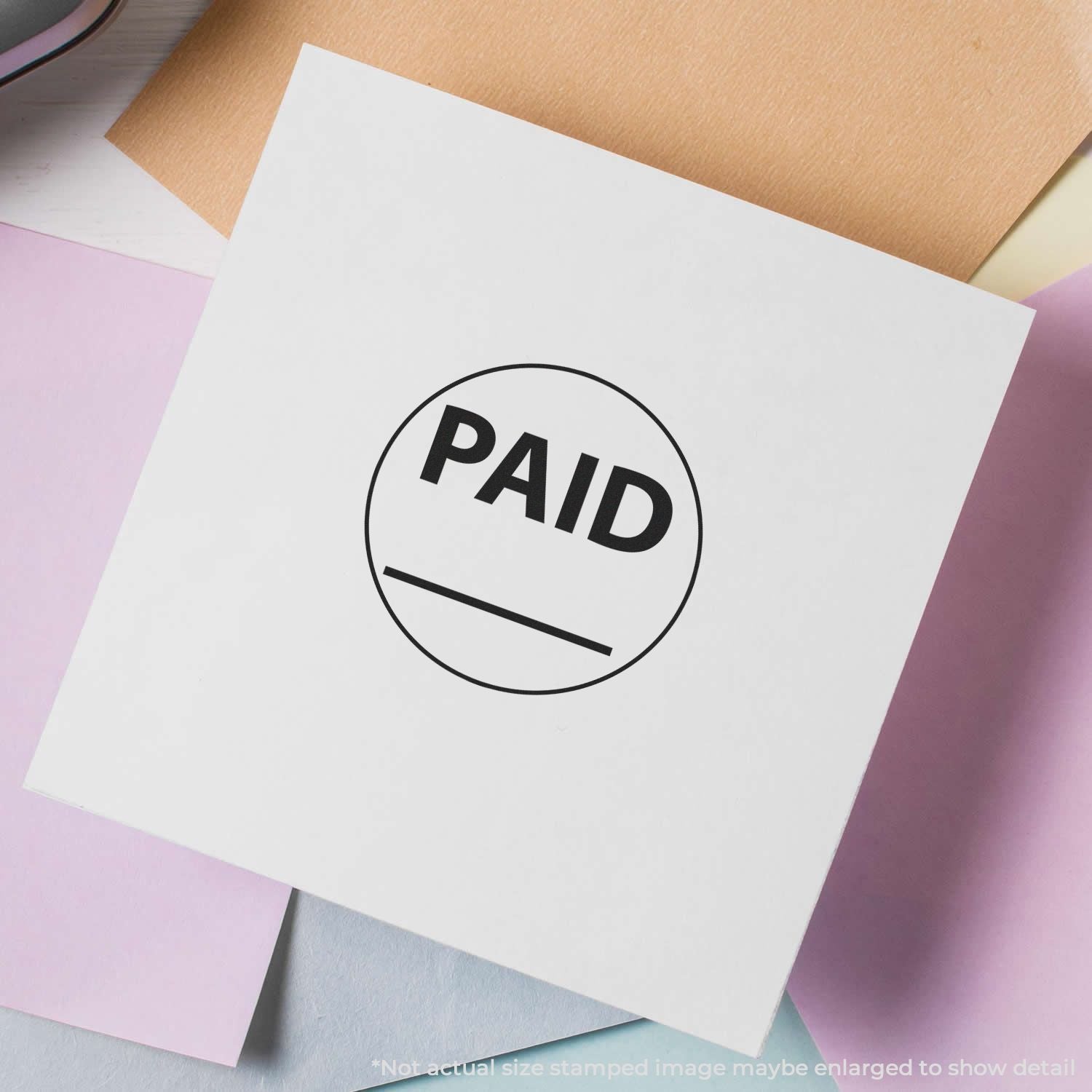 PAID stamp on white paper card over pastel envelope background, business payment confirmation and invoice status concept.