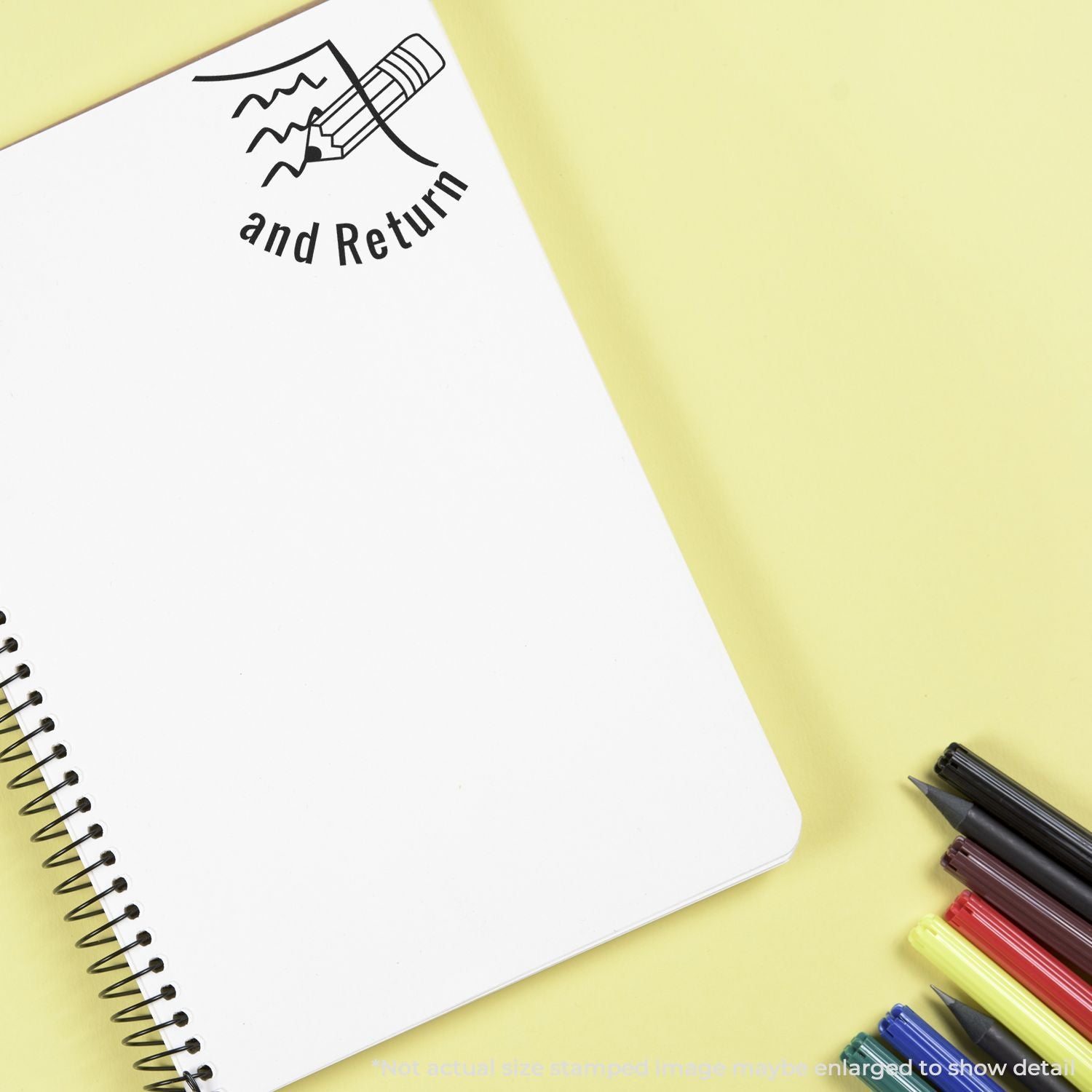 Spiral notebook with pencil icon and and Return text on yellow background, surrounded by colorful pens and markers.