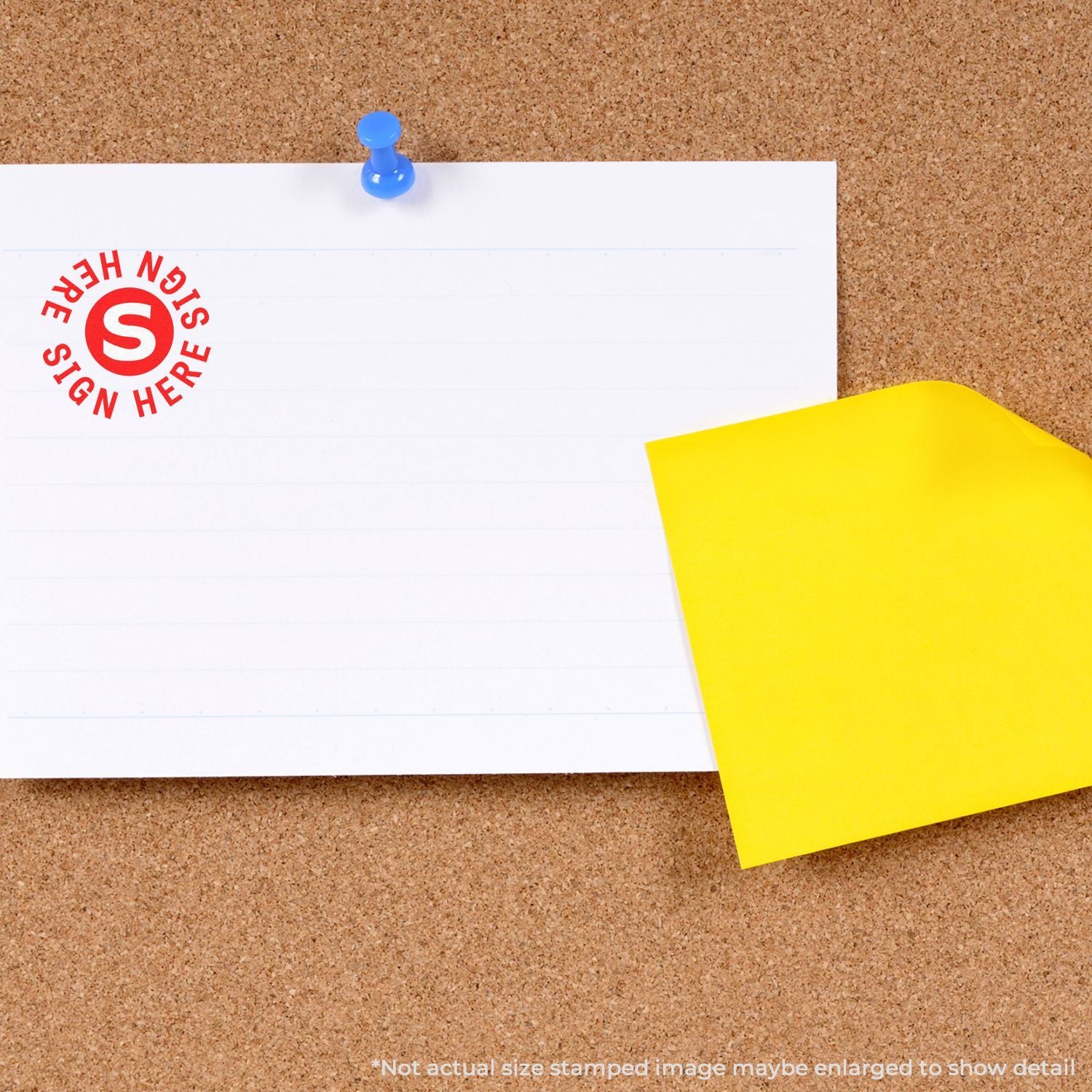 Blank white sign here note pinned to a cork bulletin board with a blue pushpin and yellow sticky note.
