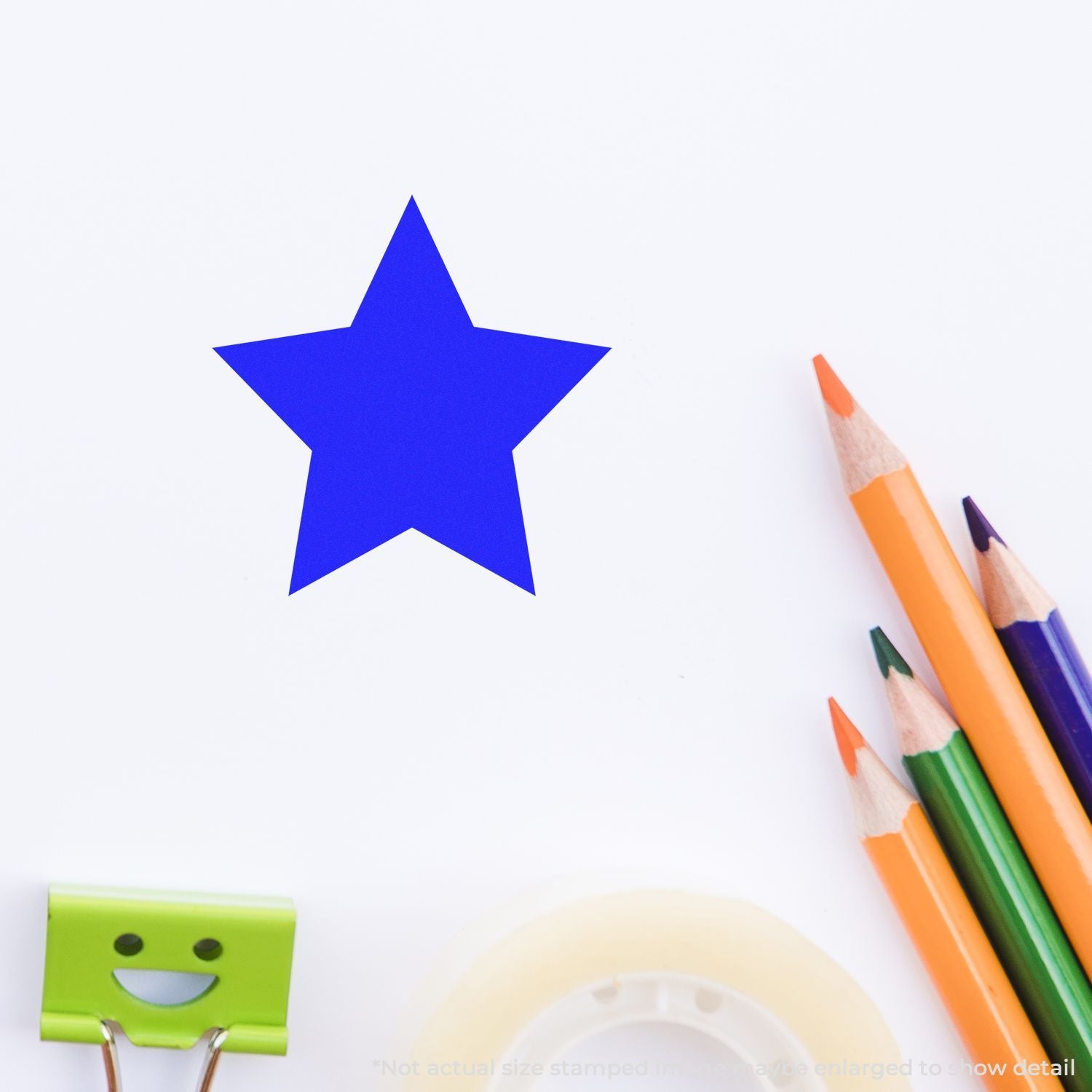 Blue star cutout with colorful pencils and a smiling green binder clip on a white background, creative school stationery composition.