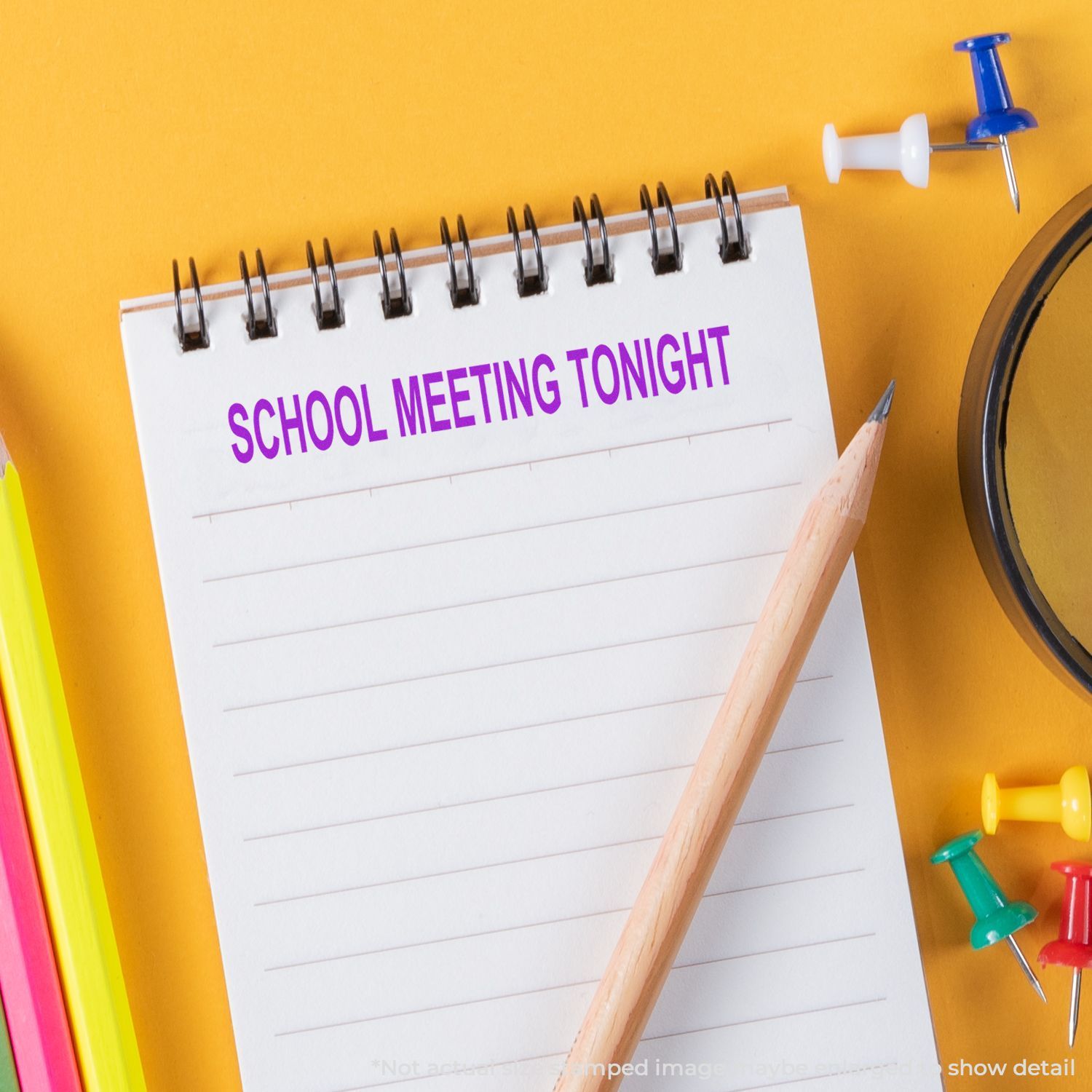 School meeting tonight reminder on a notebook with pencil and colorful stationery on a yellow background
