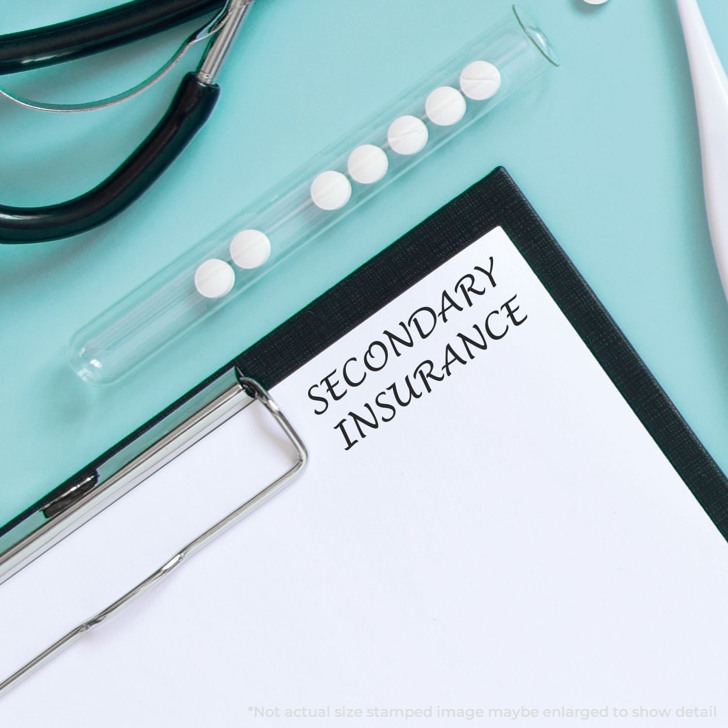Secondary insurance form on clipboard with stethoscope, pill bottle, and pen on a medical office desk.