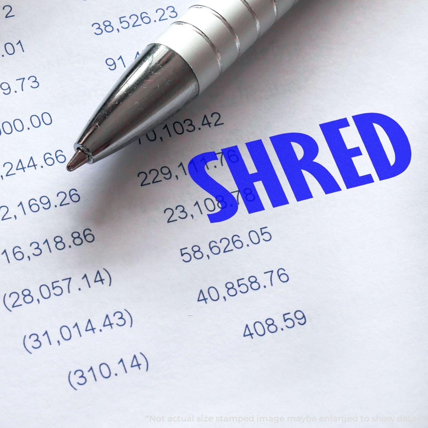 Silver pen on financial document with blue SHARED stamp, expense numbers, and accounting calculations.