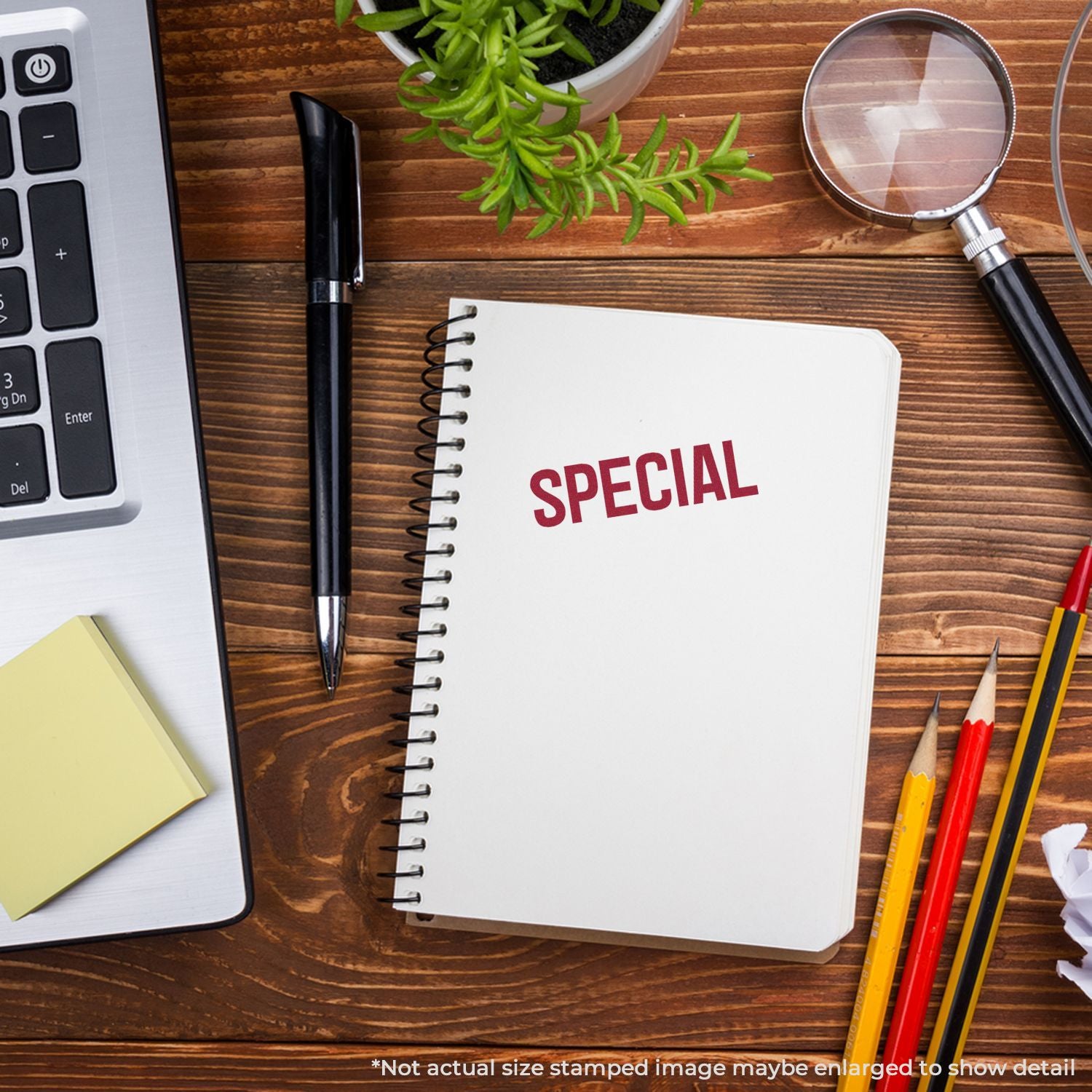 Notebook with 'SPECIAL' headline, pens and magnifying glass on wooden deskmarketing promotion idea.