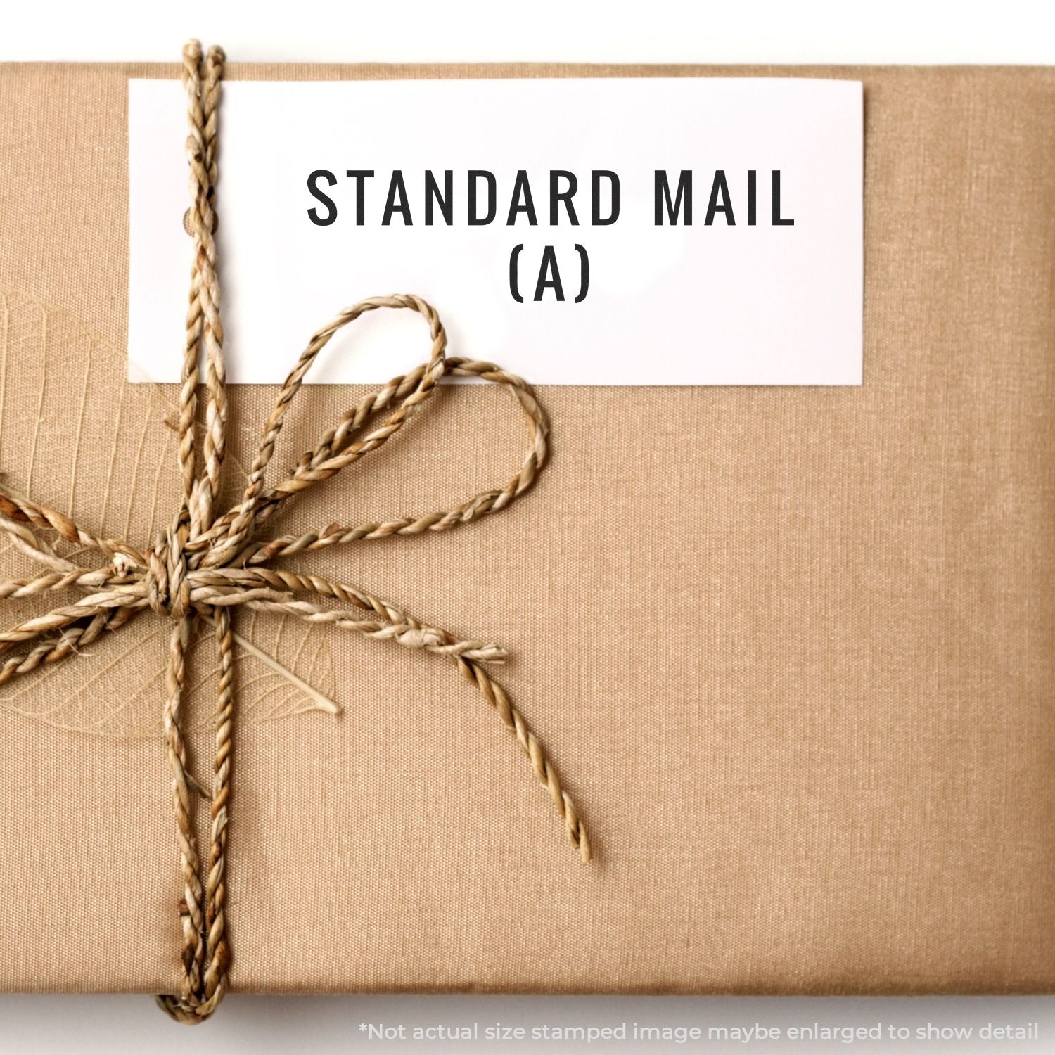 Standard mail package labeled STANDARD MAIL (A) tied with twine for USPS bulk shipping and mailing services.