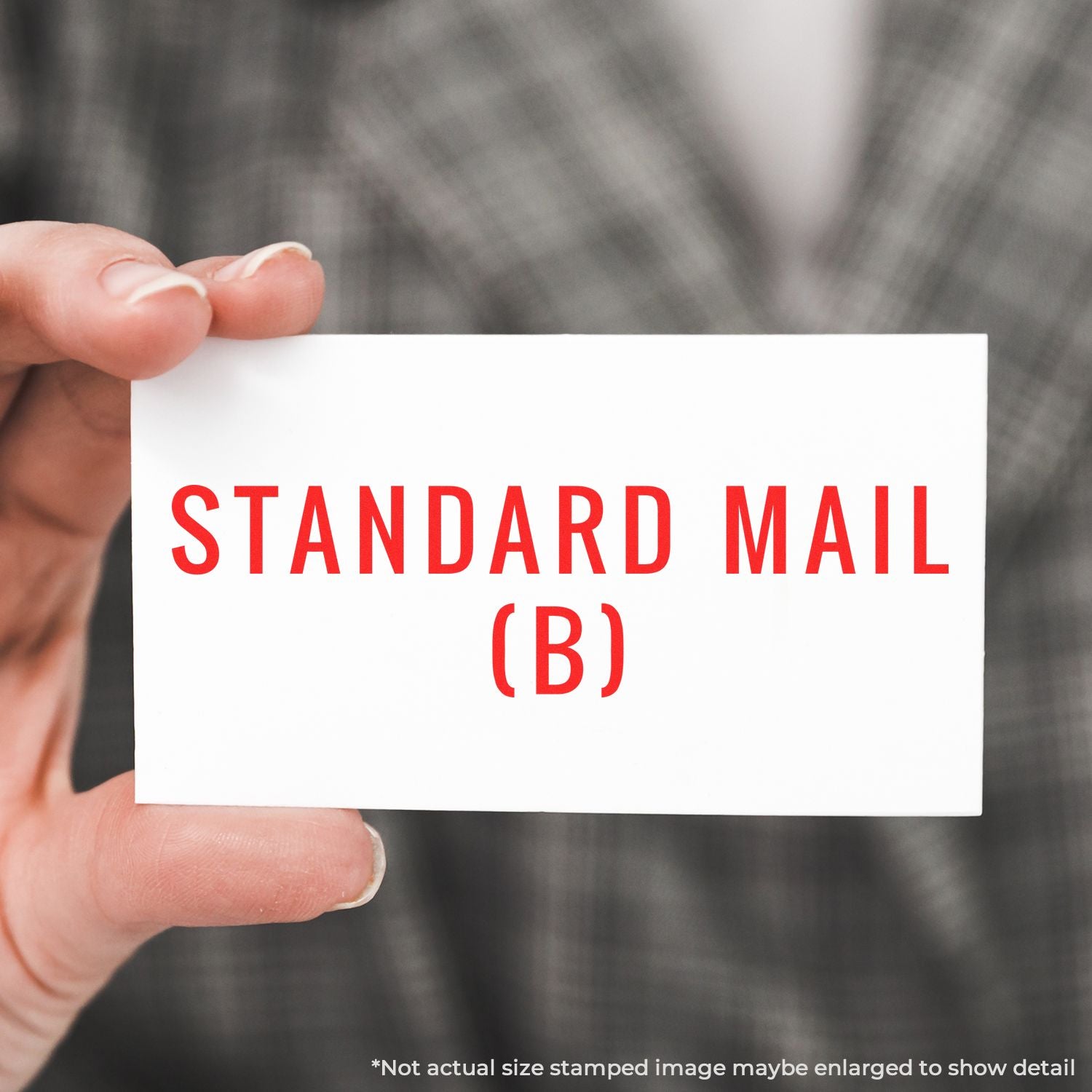 Hand holding a Standard Mail (B) stamp card, representing USPS standard mail delivery for letters and mailings