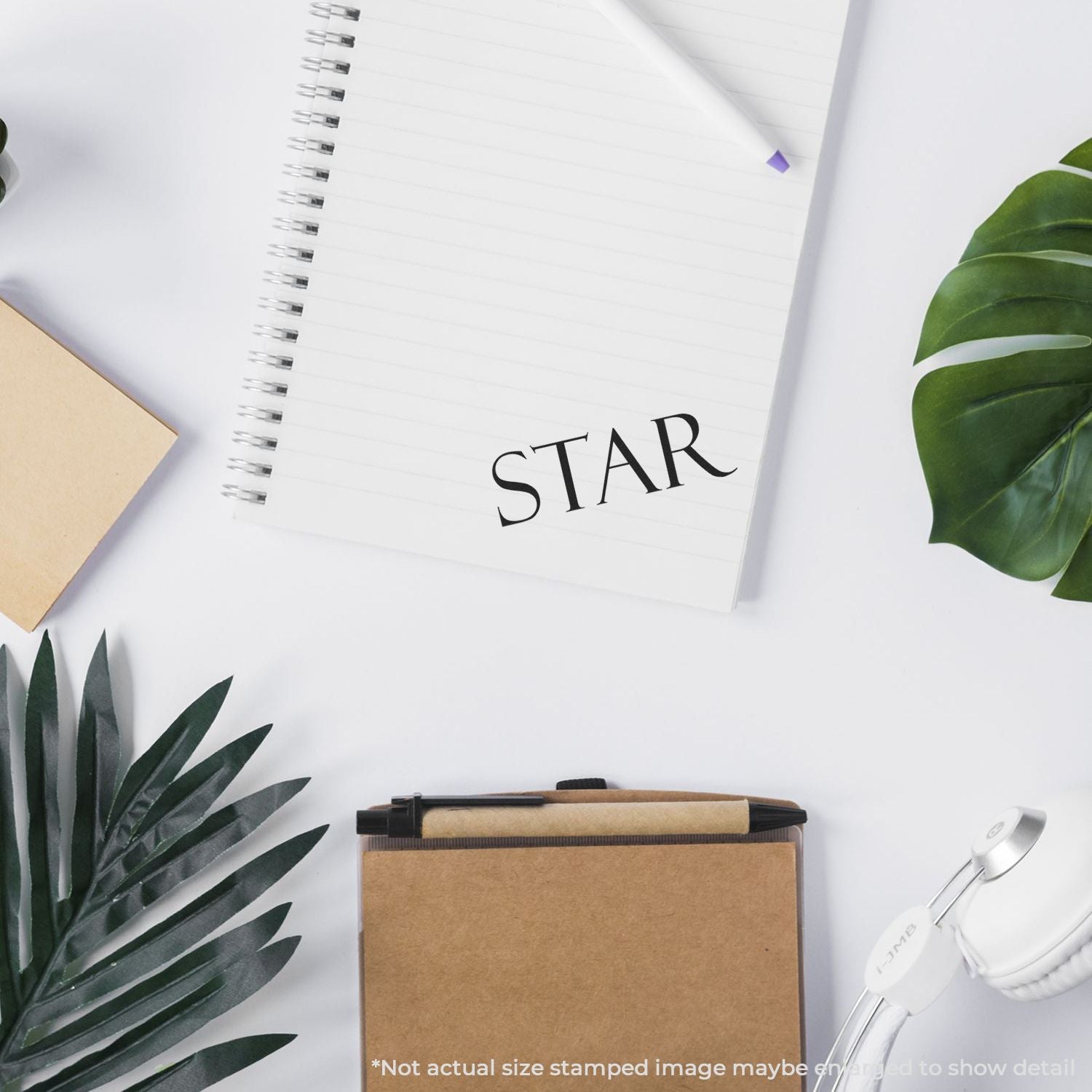 Clean desk scene with STAR notebook, pens, sticky notes and plantsbusiness planning and branding concept