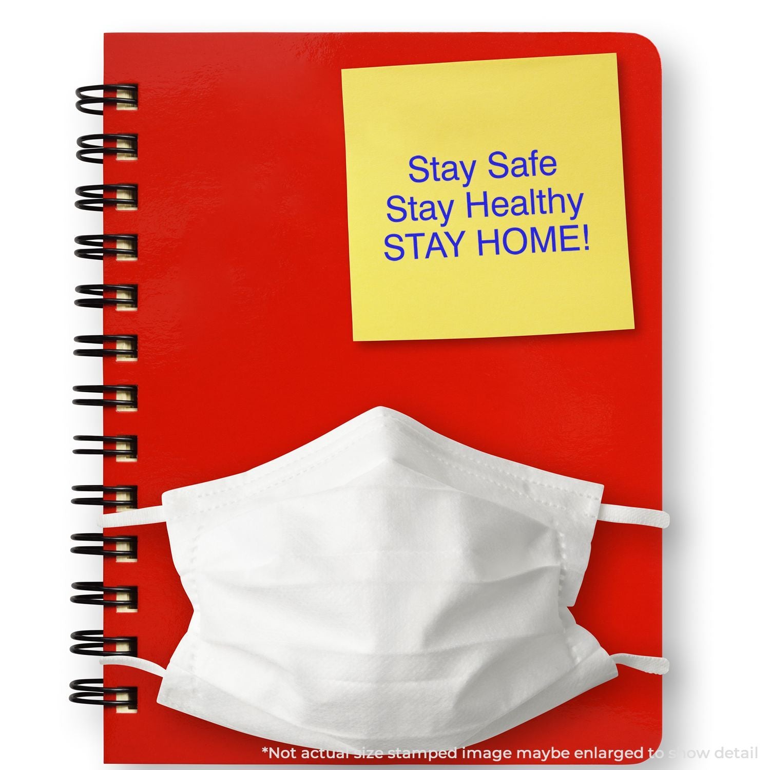 Red notebook with a yellow stay home safety note and a white protective face mask, promoting health and social distancing.