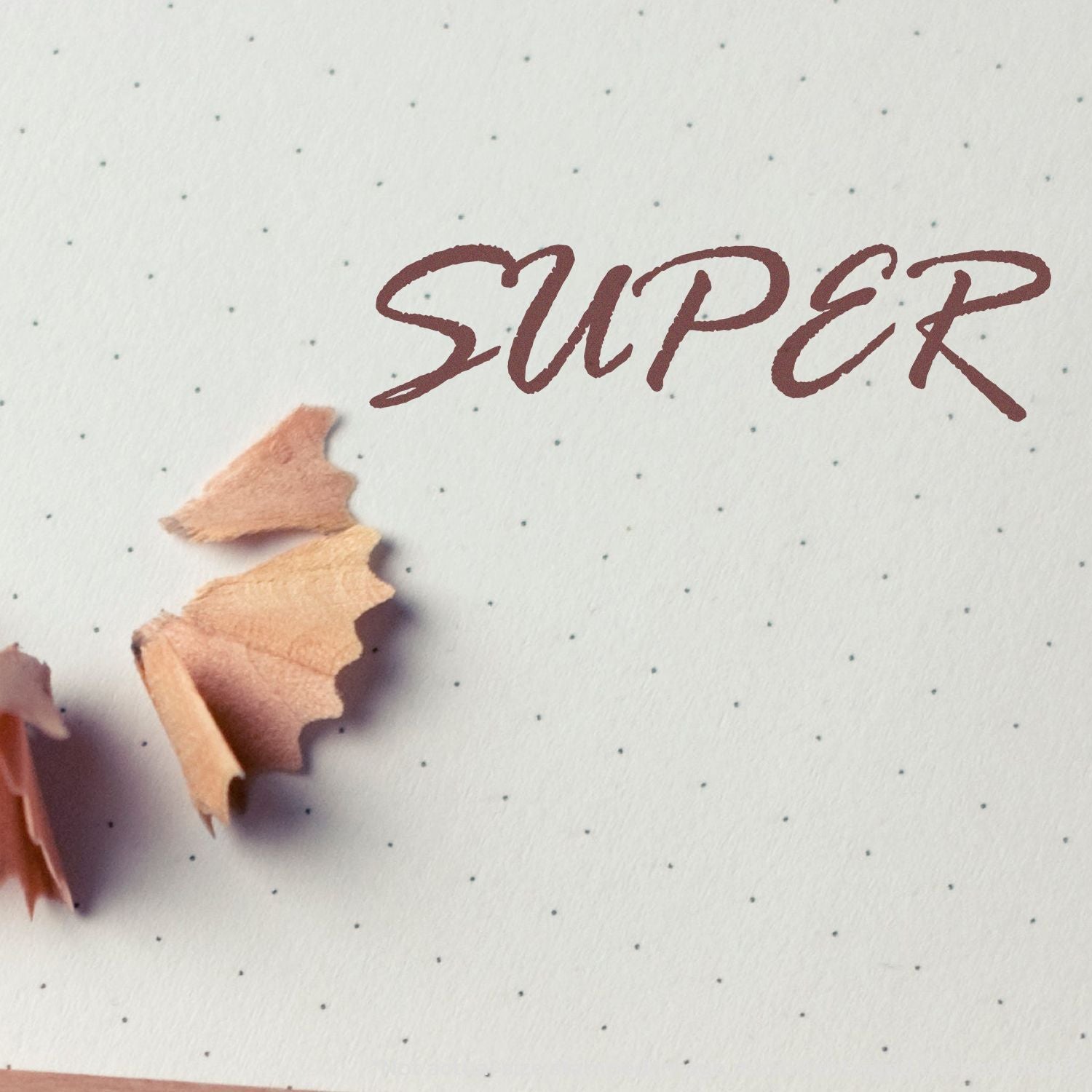 SuperX logo text in burgundy ink on speckled white paper, with torn cardboard edge for a handcrafted typography branding design.