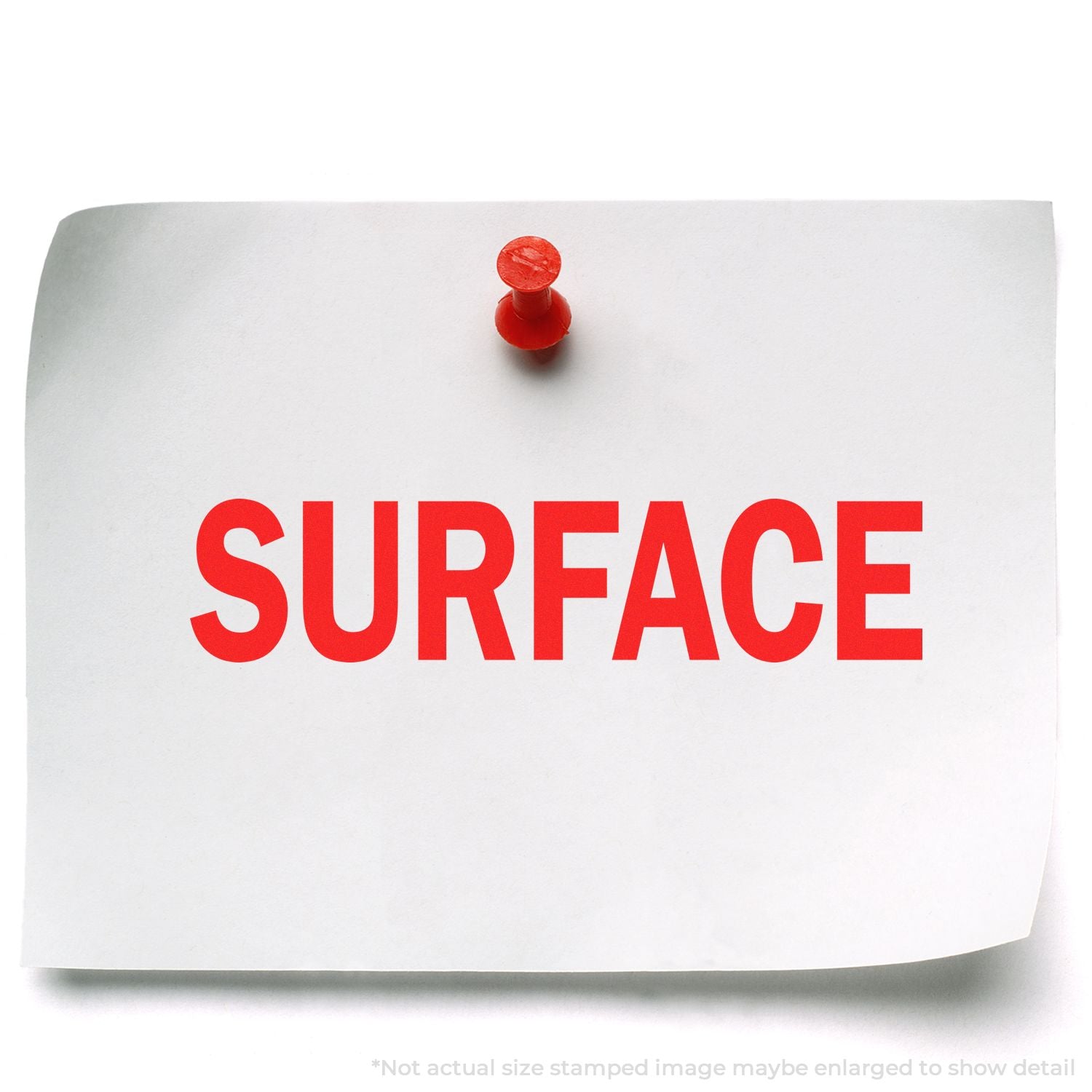 White sticky note pinned with a red push pin, featuring the word SURFACE in bold red letters.