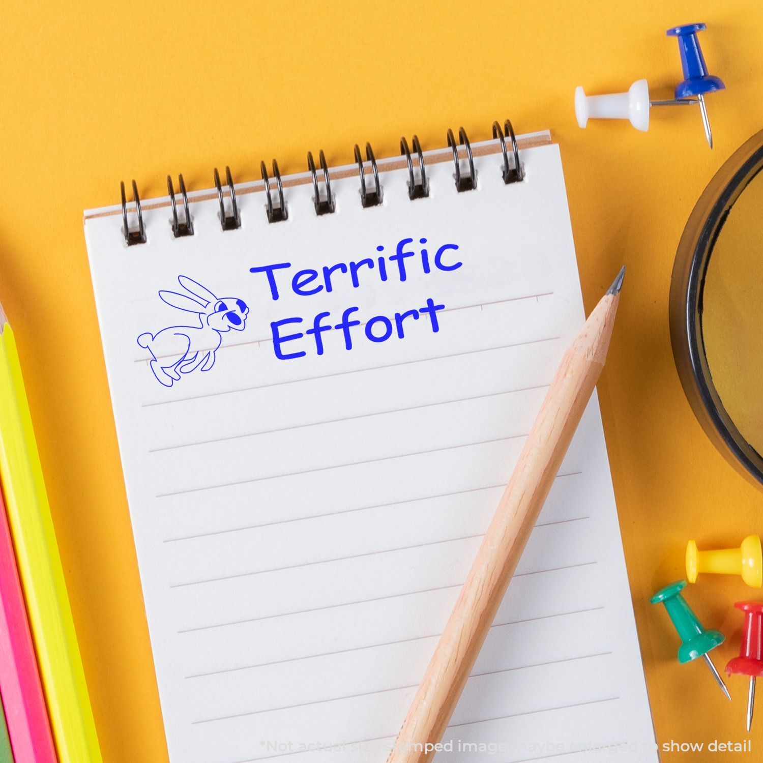 Notepad with Terrific Effort text, pencil, and colorful school supplies on yellow background, motivational school concept.