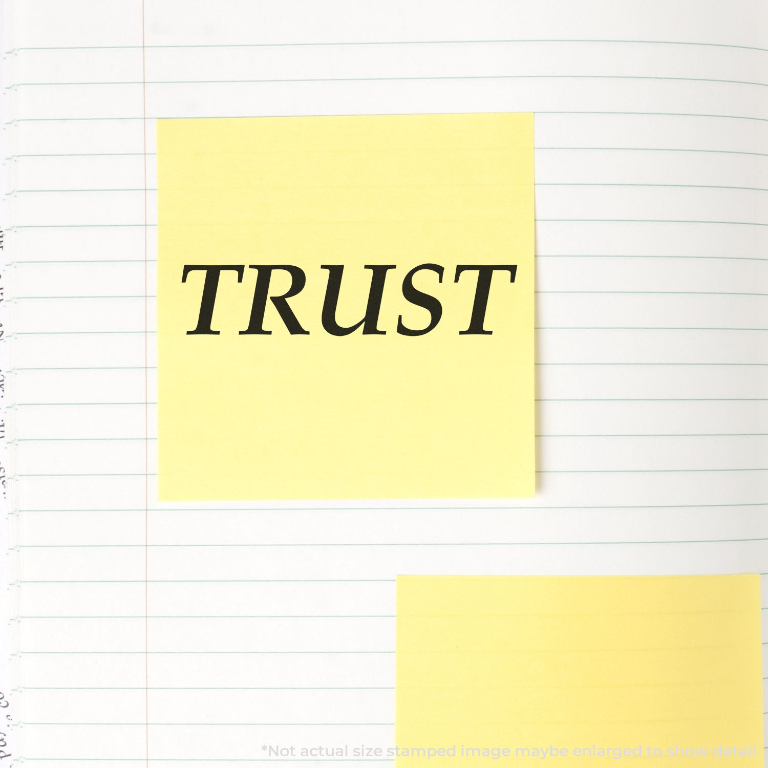 Yellow sticky note with the word TRUST on lined notebook paper, symbolizing confidence, faith, and trust concept.