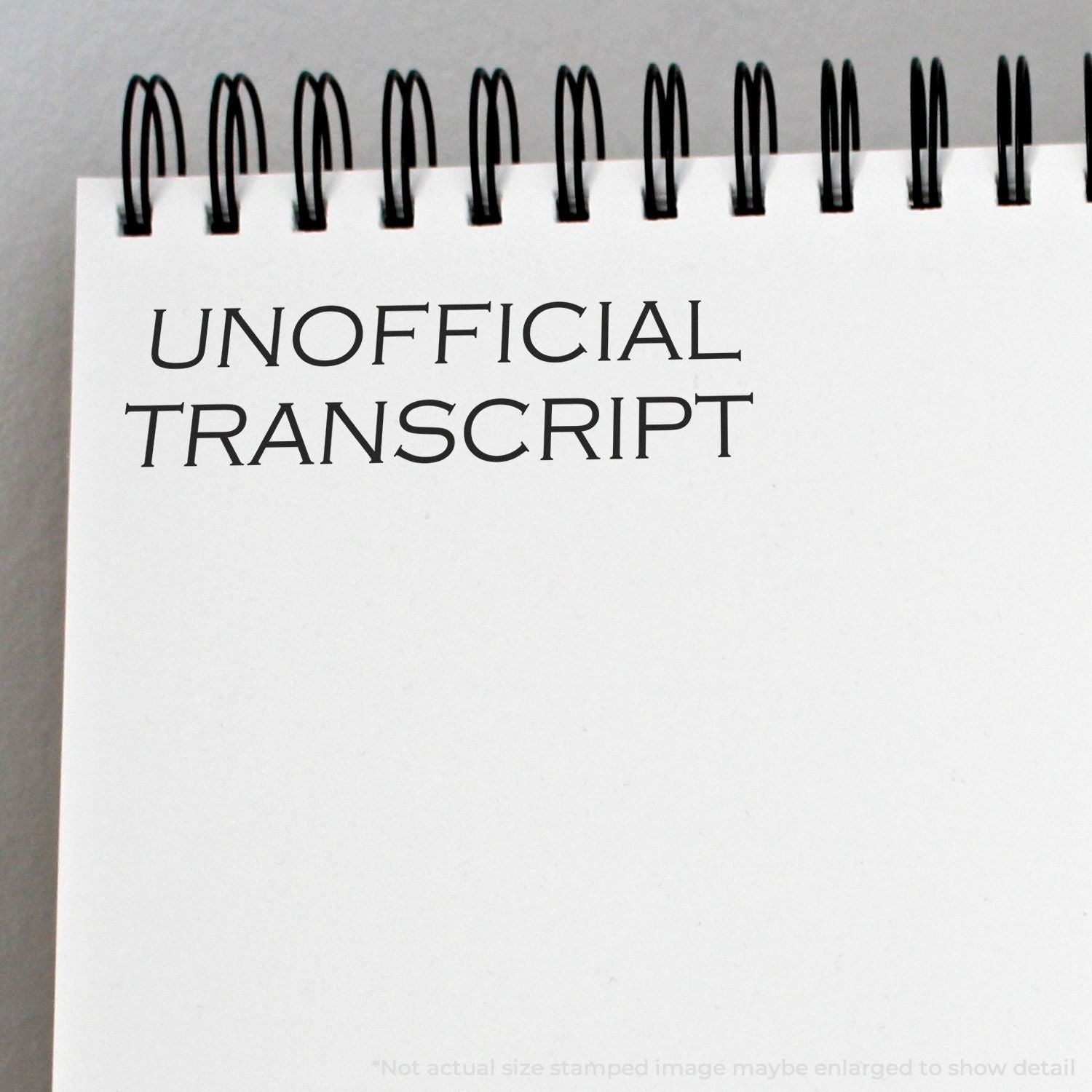 Spiral notebook page with the words Unofficial Transcript printed on a blank white cover.