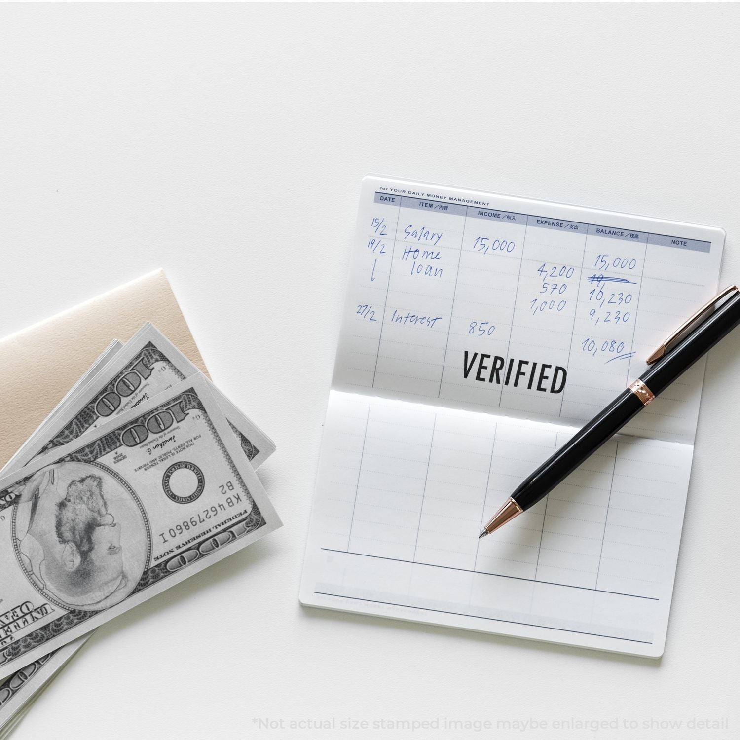 Money management ledger with cash, pen, and verified financial records on a clean white desk.