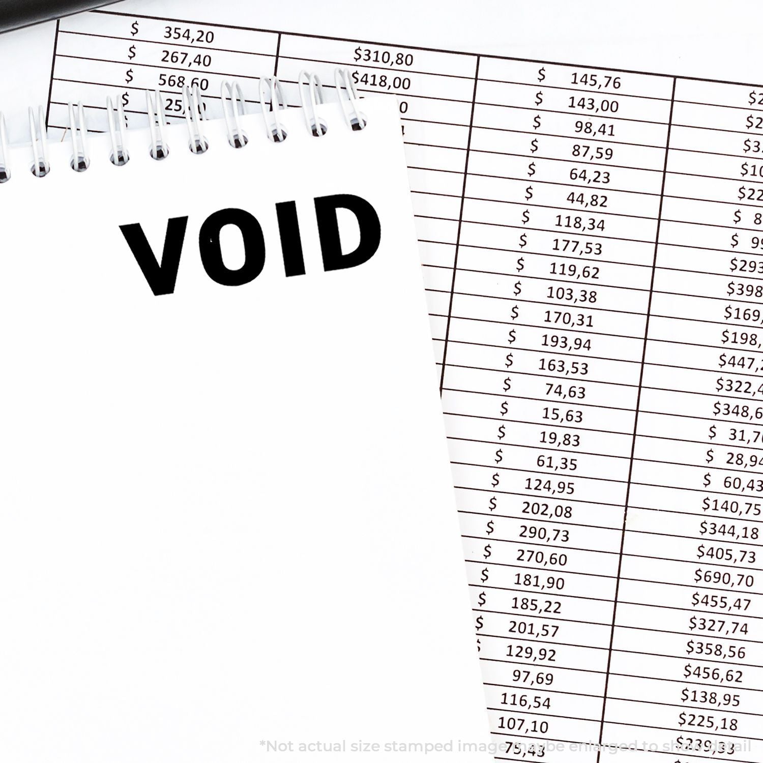 Blank notepad stamped VOID over a financial accounting spreadsheet, symbolizing a canceled invoice or document.