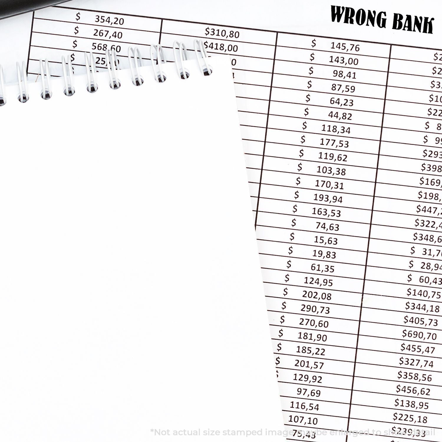 Blank spiral notebook over bank statement with WRONG BANK text and money amounts on a financial document.