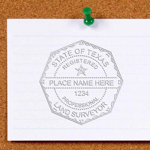 Hand-drawn Texas registered professional land surveyor seal template pinned to a corkboard.
