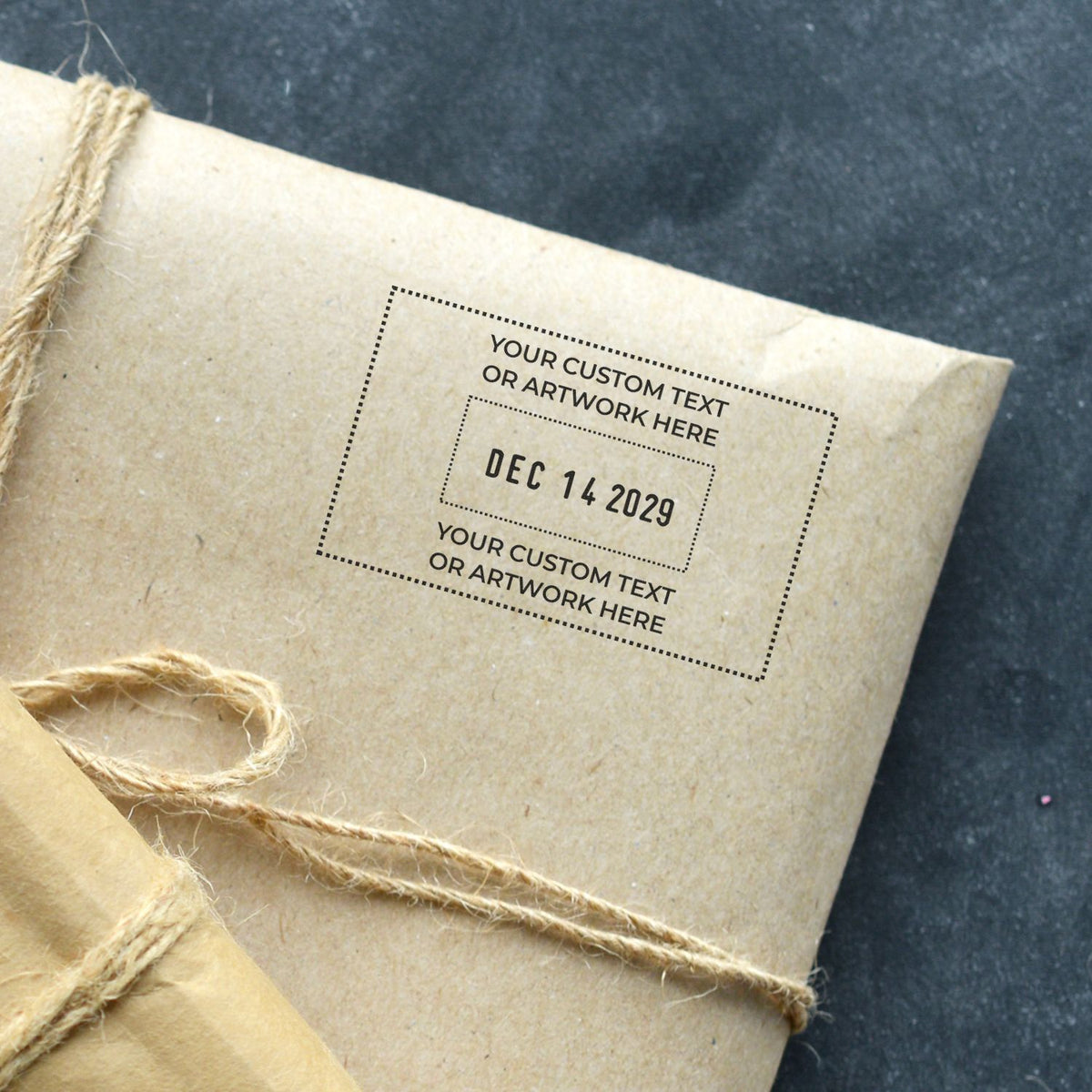 Rustic kraft paper gift wrapped with twine and personalized custom date stamp for wedding or holiday packaging