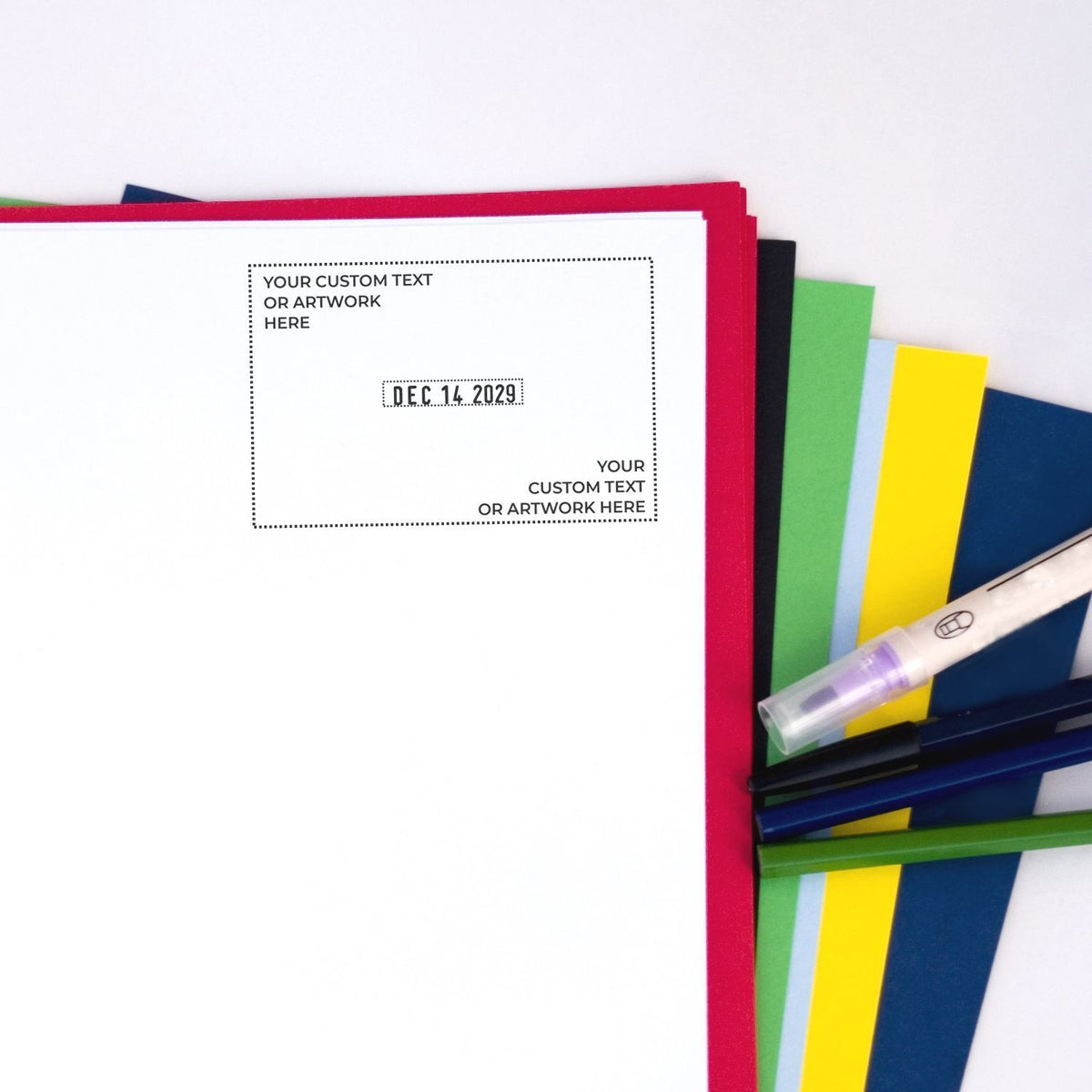 Customizable notebook cover template with colorful paper tabs, pens, and placeholder text for artwork or date.