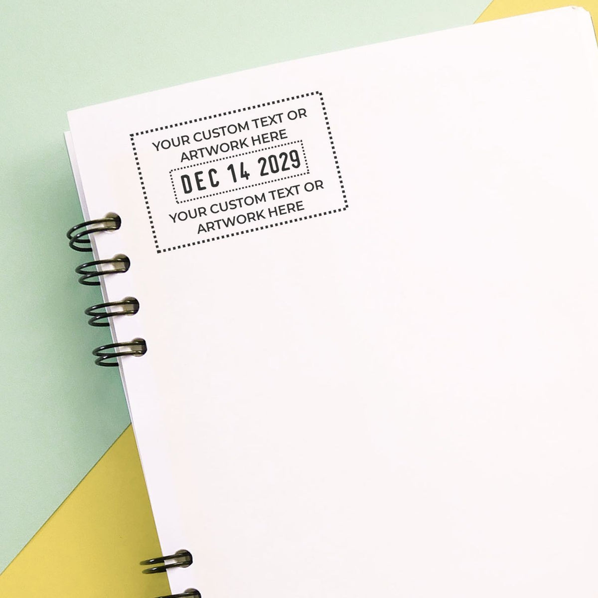 Blank spiral notebook mockup with customizable text and date stamp on a pastel background