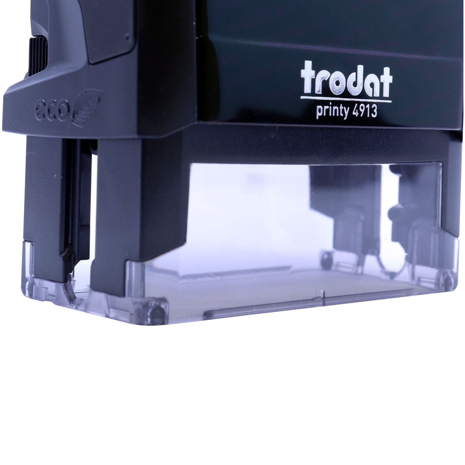 Close-up of Trodat Printy 4913 eco-friendly self-inking stamp with black body and transparent base.