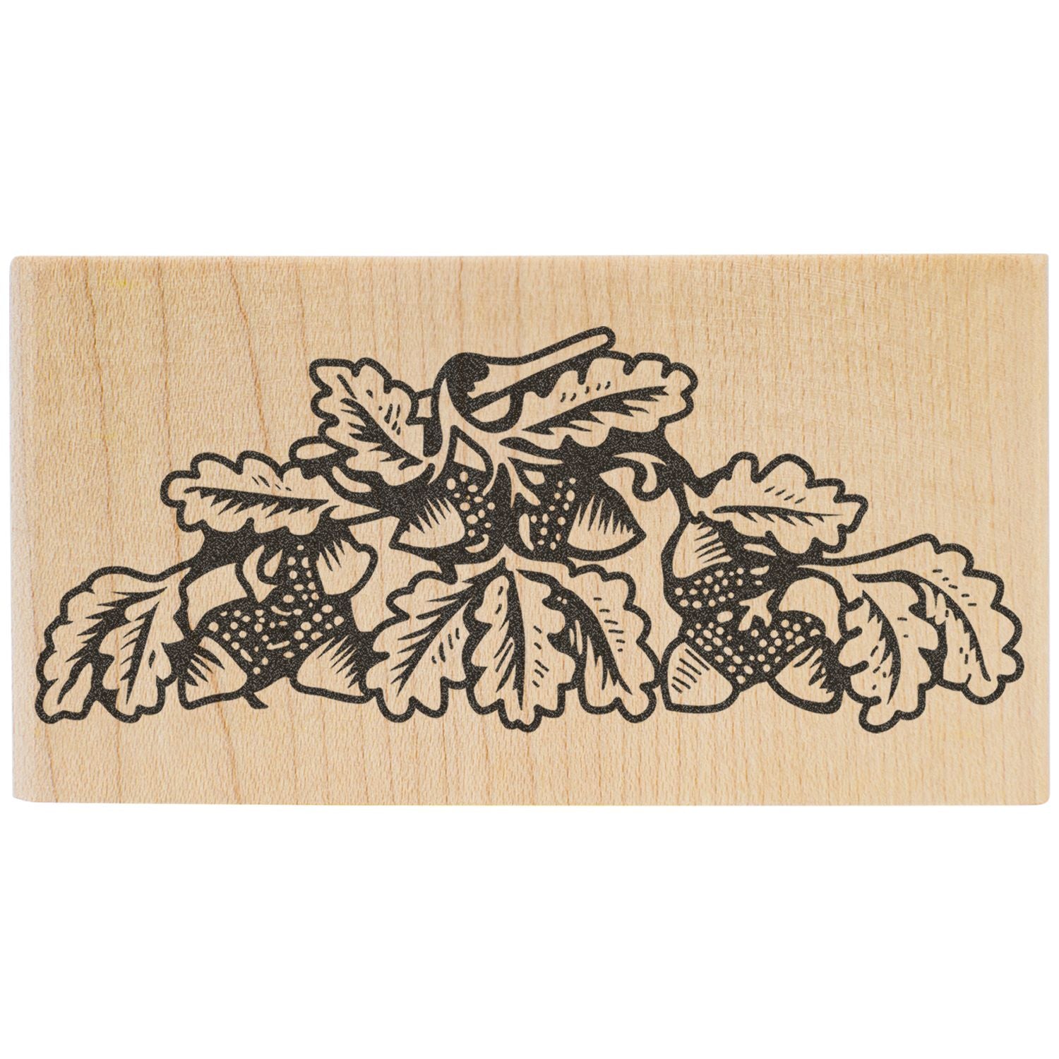 Wooden rubber stamp with decorative black floral leaf and berry design on a light wood block