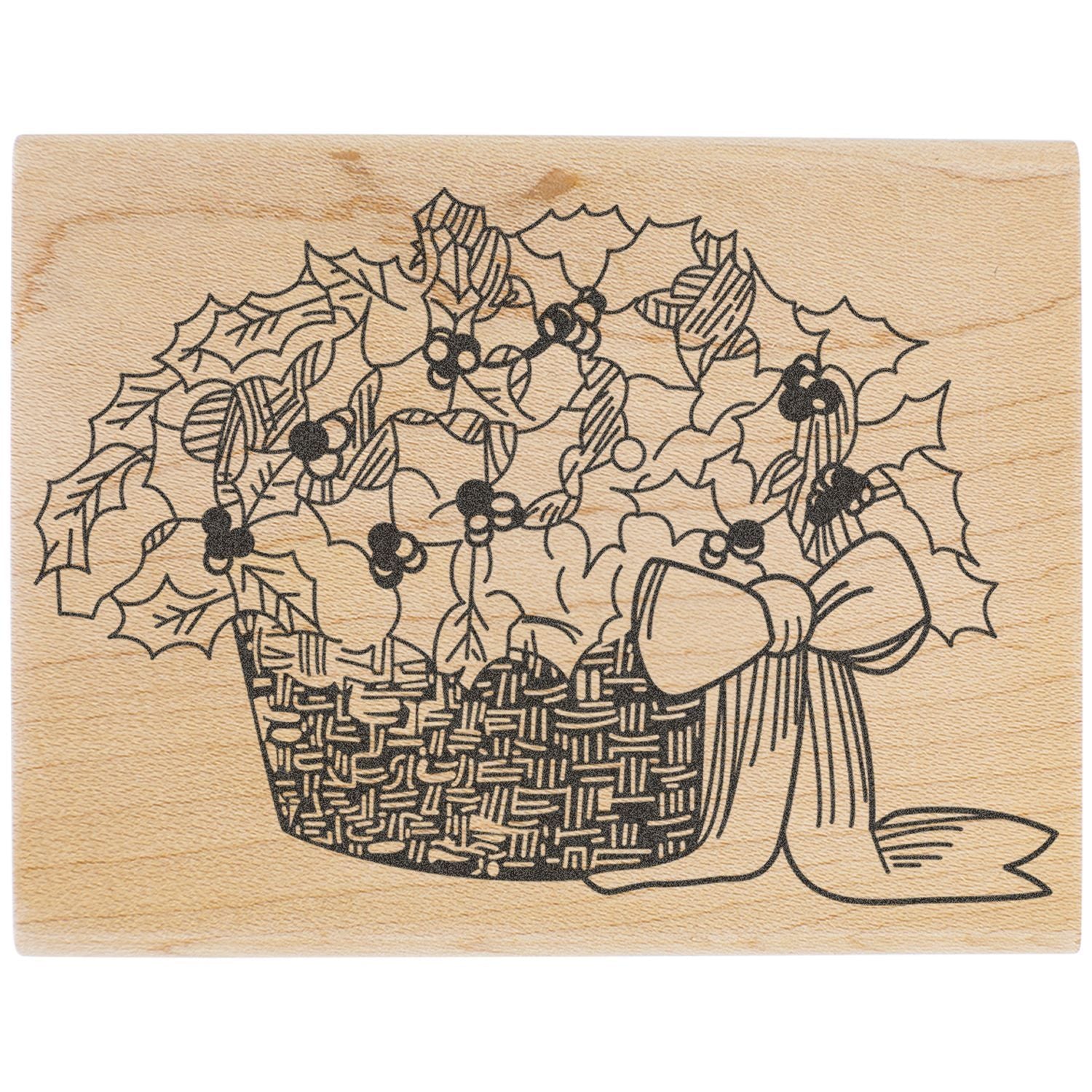 Wooden holiday stamp with engraved Christmas basket filled with holly leaves, berries, and ribbon.
