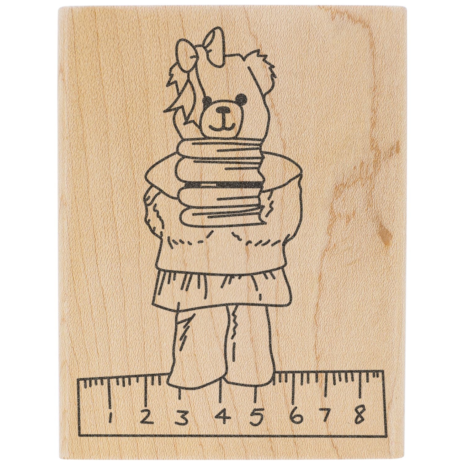 Wooden rubber stamp design of a cute bear girl holding books, standing on a ruler, black line art on wood block.