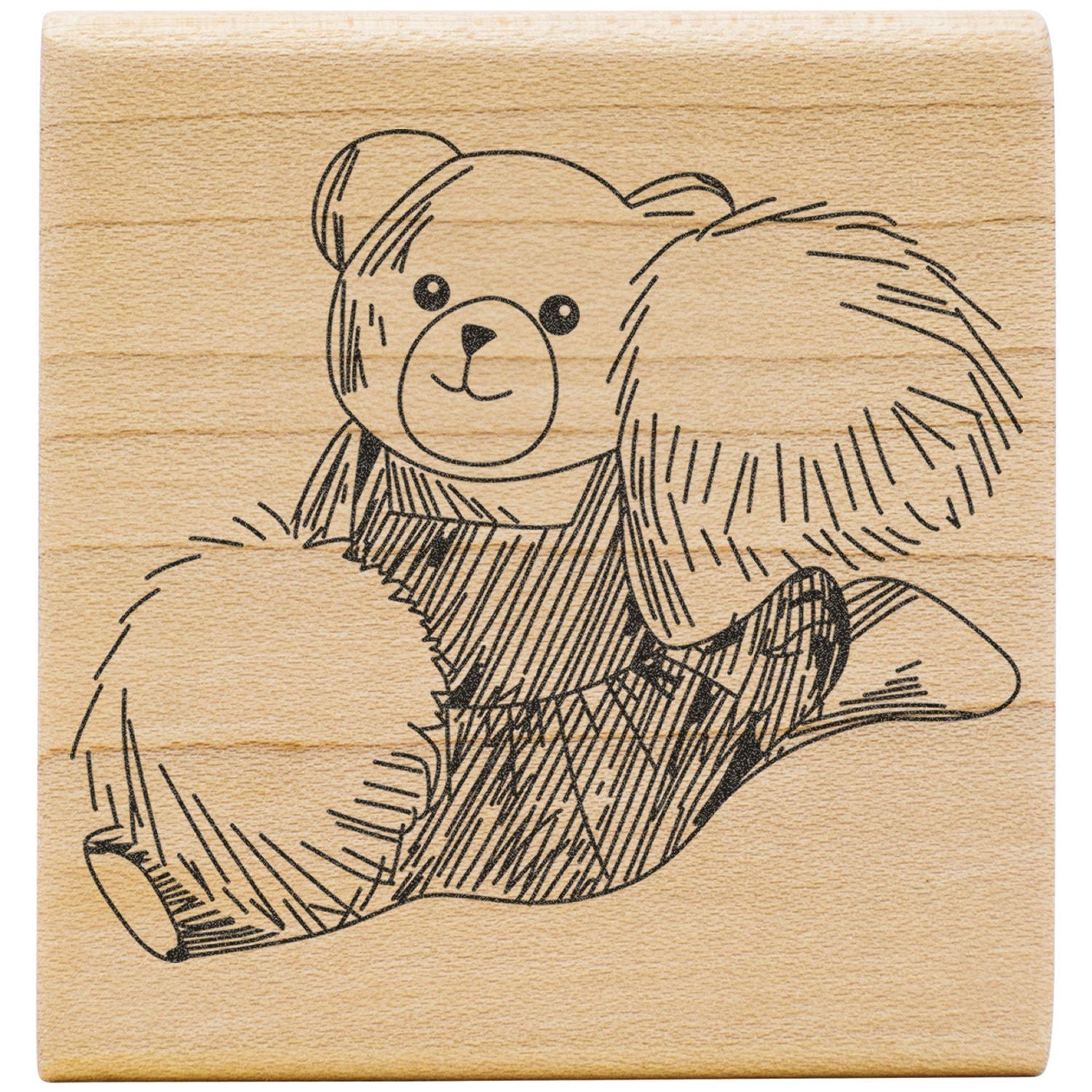 Engraved teddy bear illustration on wooden block, cute bear line art on natural wood background.