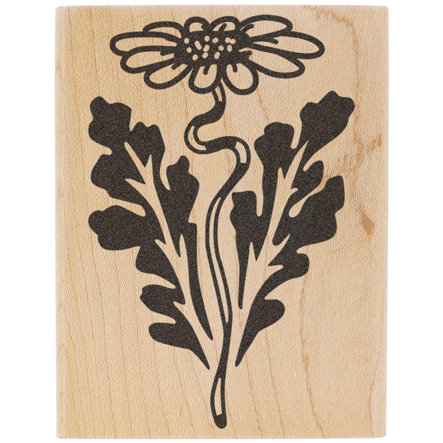 Black floral botanical stamp design on a natural wood block.