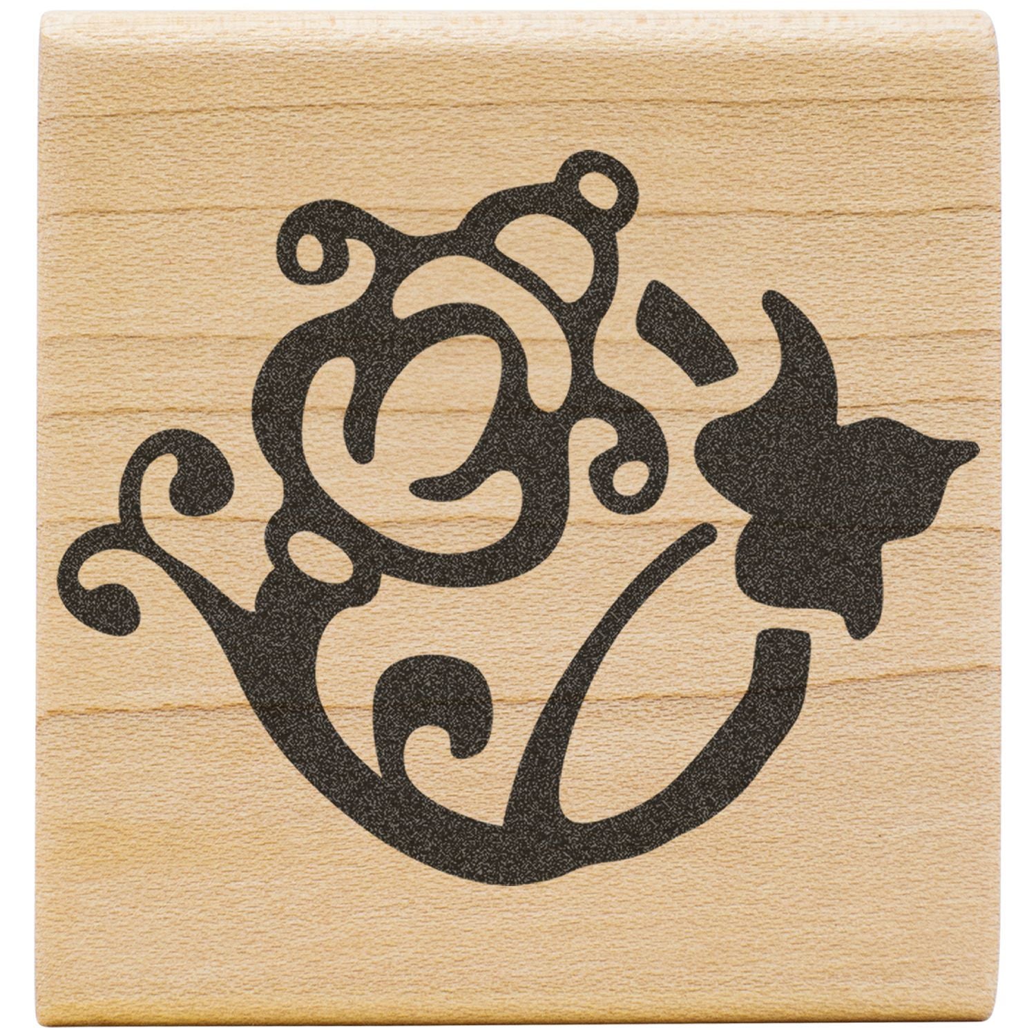 Decorative black bear silhouette with tribal floral design on a wooden block