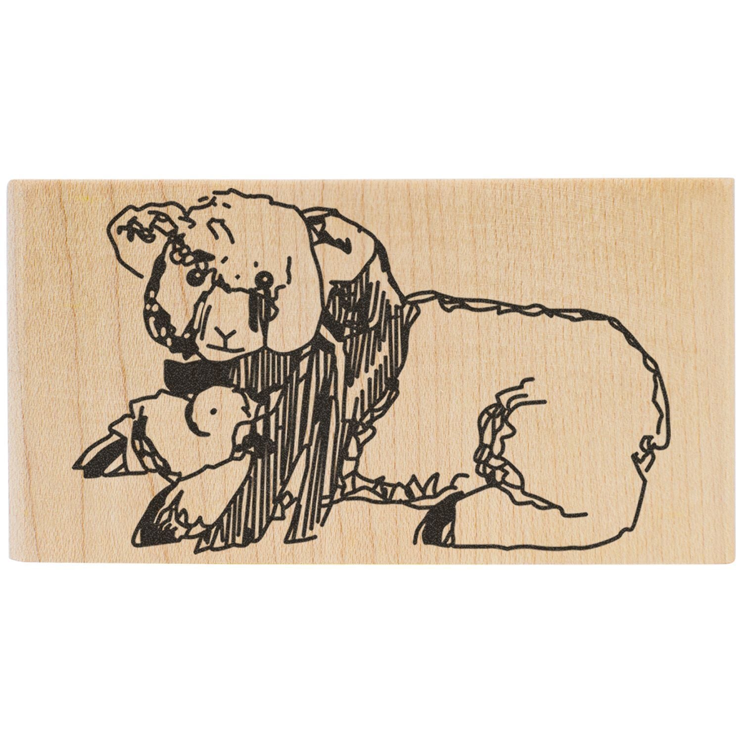 Hand-carved wooden stamp with black line art of a sheep on natural wood background