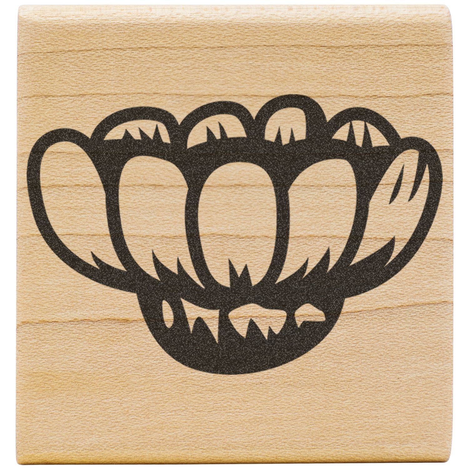 Black floral stamp design on a natural wood block background