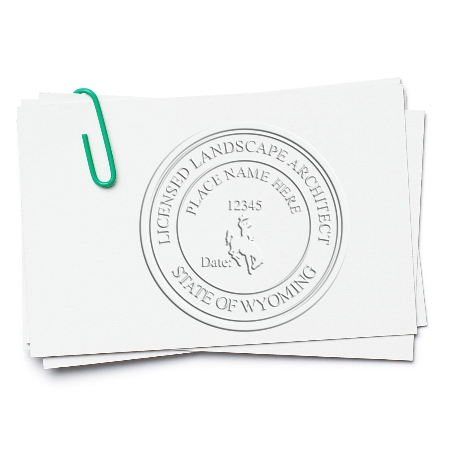 Stack of licensed landscape architect documents with Wyoming seal and paperclip on white background