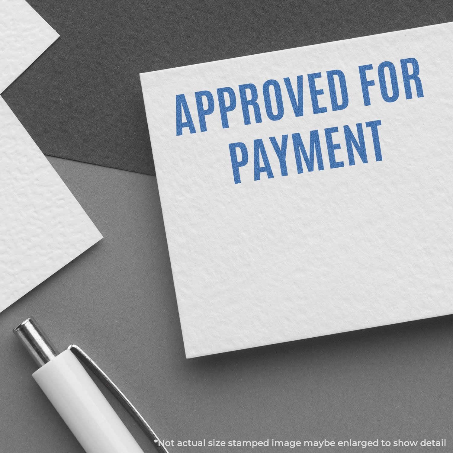 Approved for payment stamp on paperwork with pen, illustrating billing approval and invoice processing.