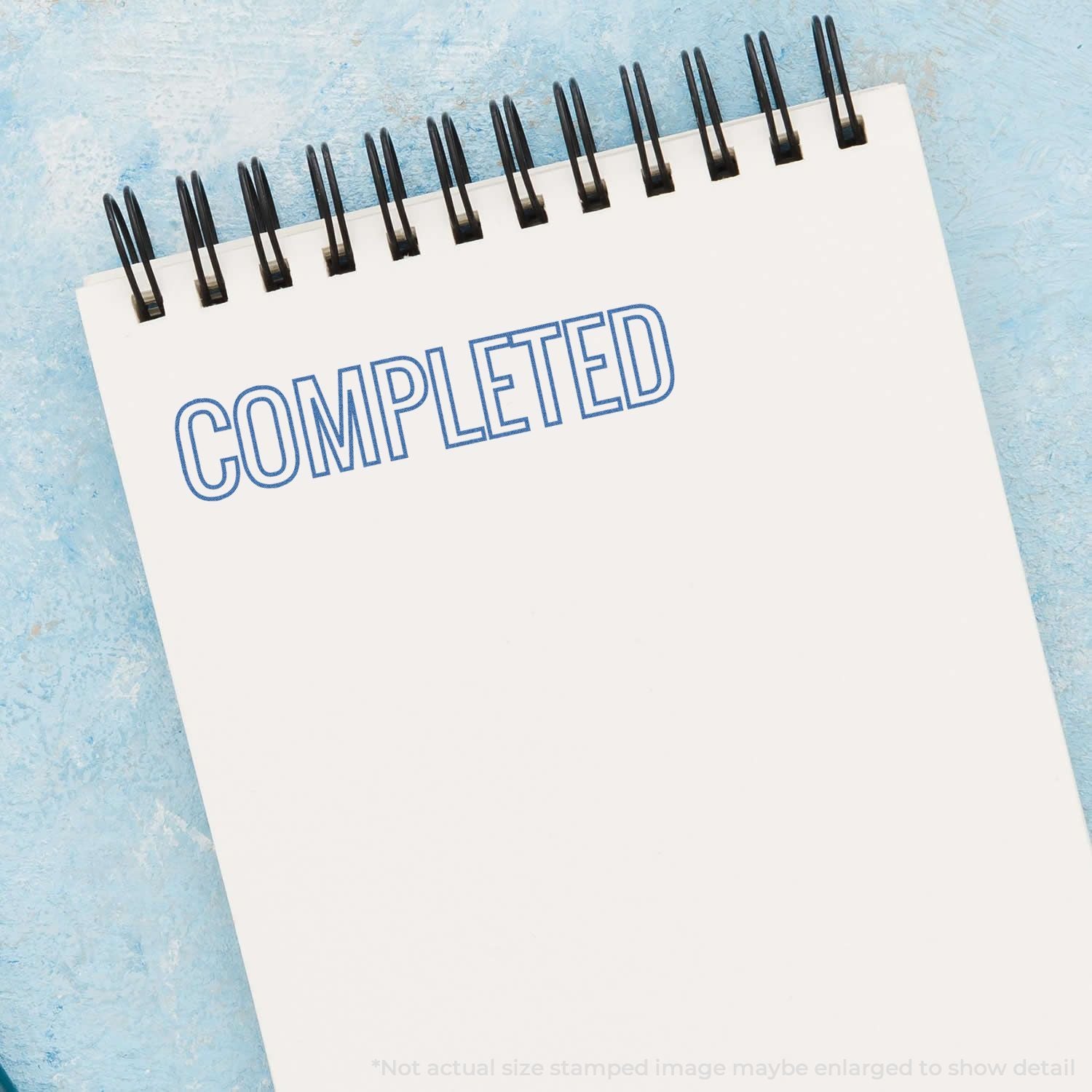 Completed stamp on desk calendar mockup with blue background, highlighting project completion and workflow status update.