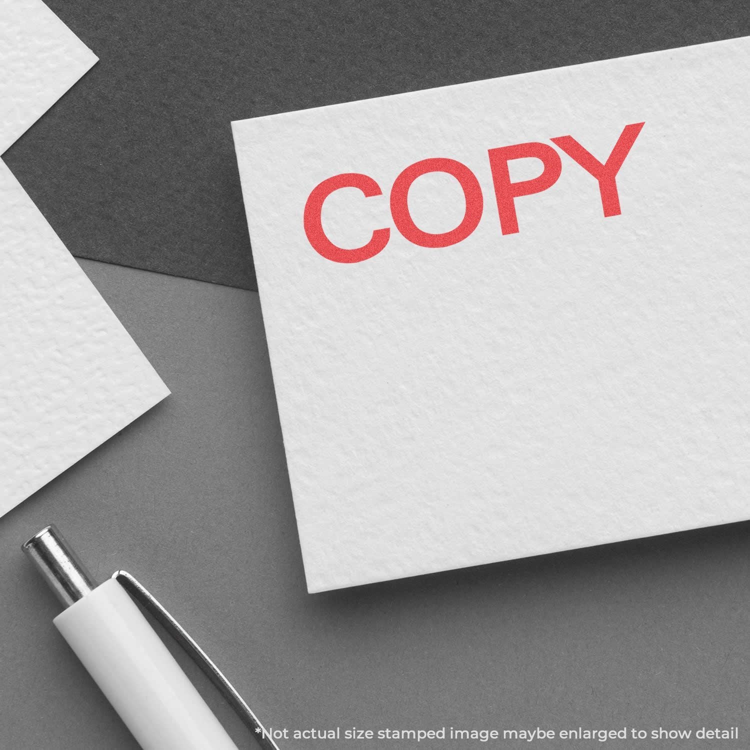 Red COPY stamped card with pen on gray background, representing copywriting and marketing content creation.