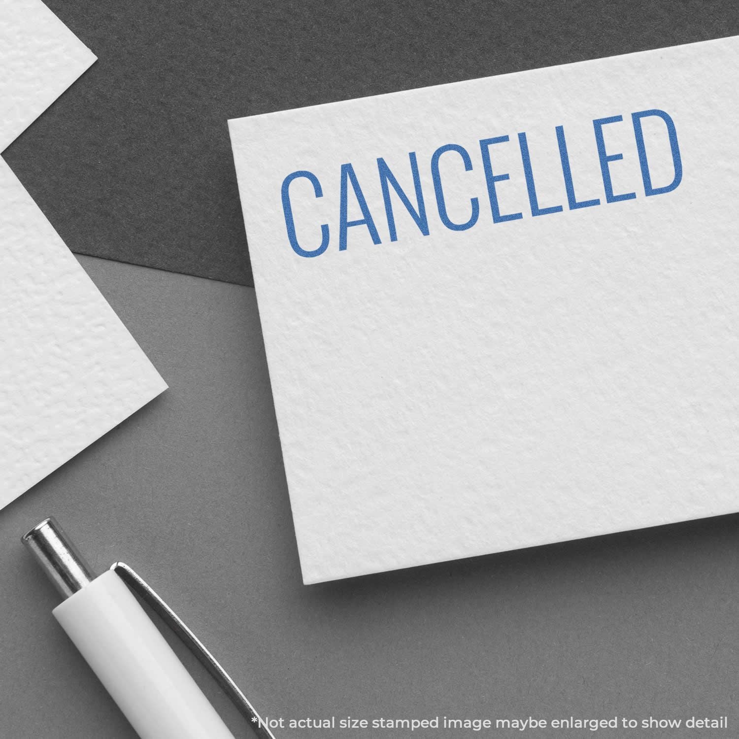 Cancelled stamp message on white paper card with pen on desk, emphasizing event cancellation notice and paperwork