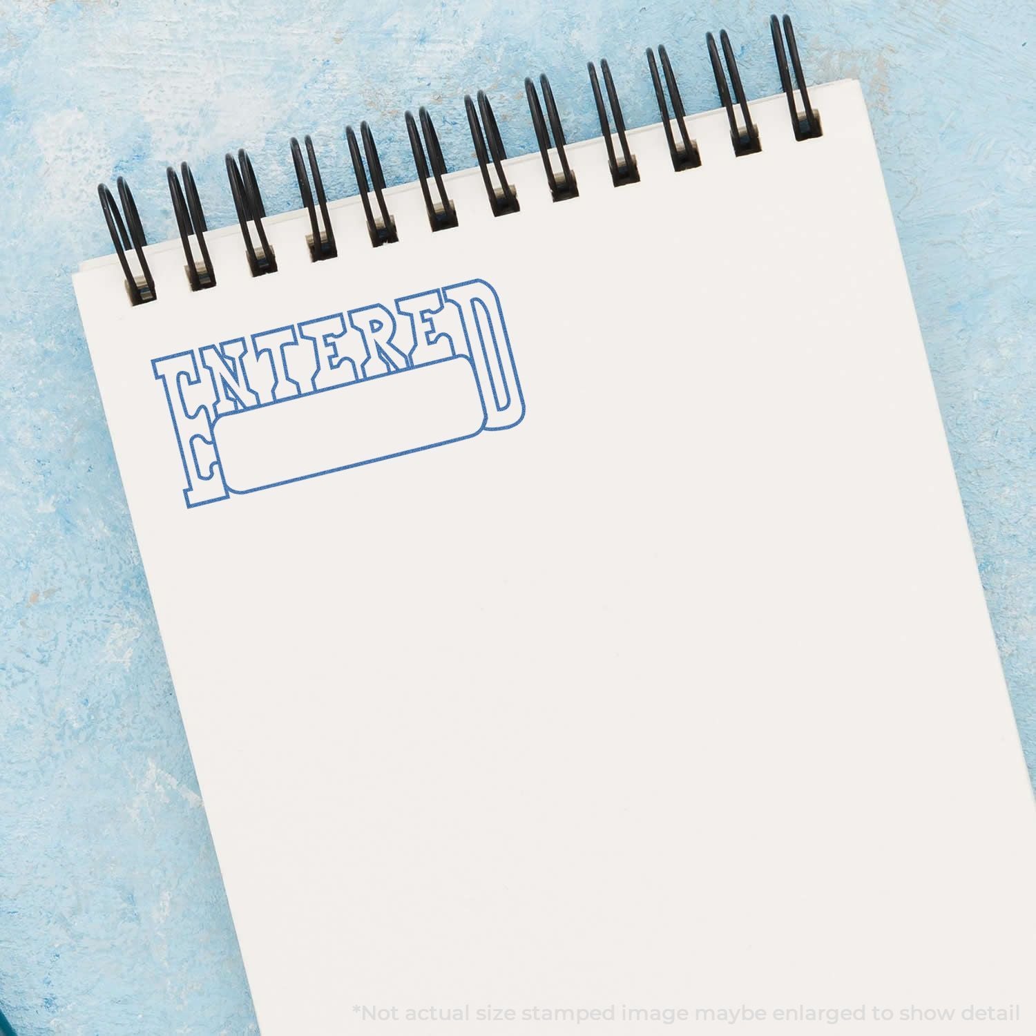 Calendar page with blue ENTER stamp and metal binder rings, representing planning deadlines and event entry.