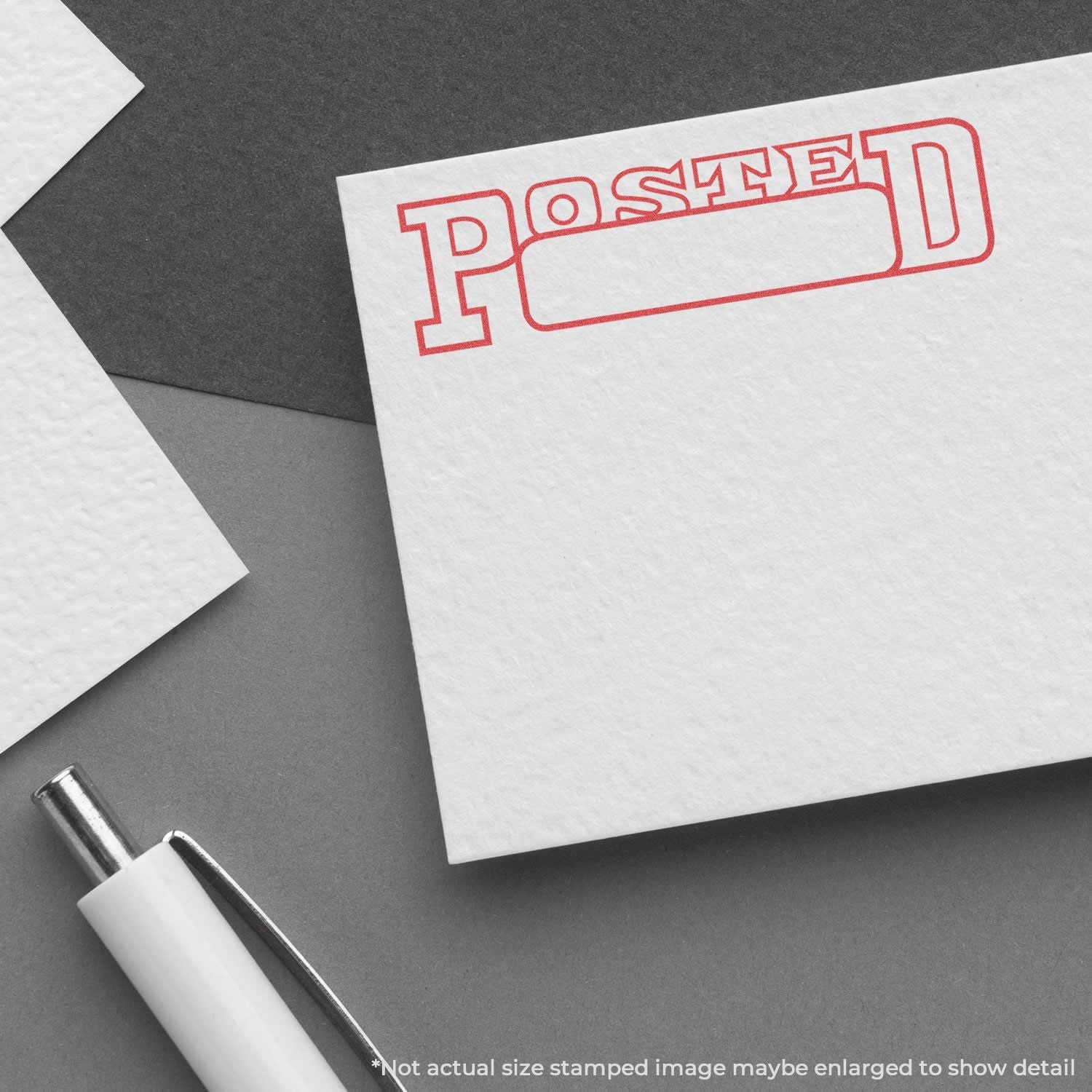 Red POSTED stamp on white stationery card with pen on dark backgrounddelivery confirmation for documents.