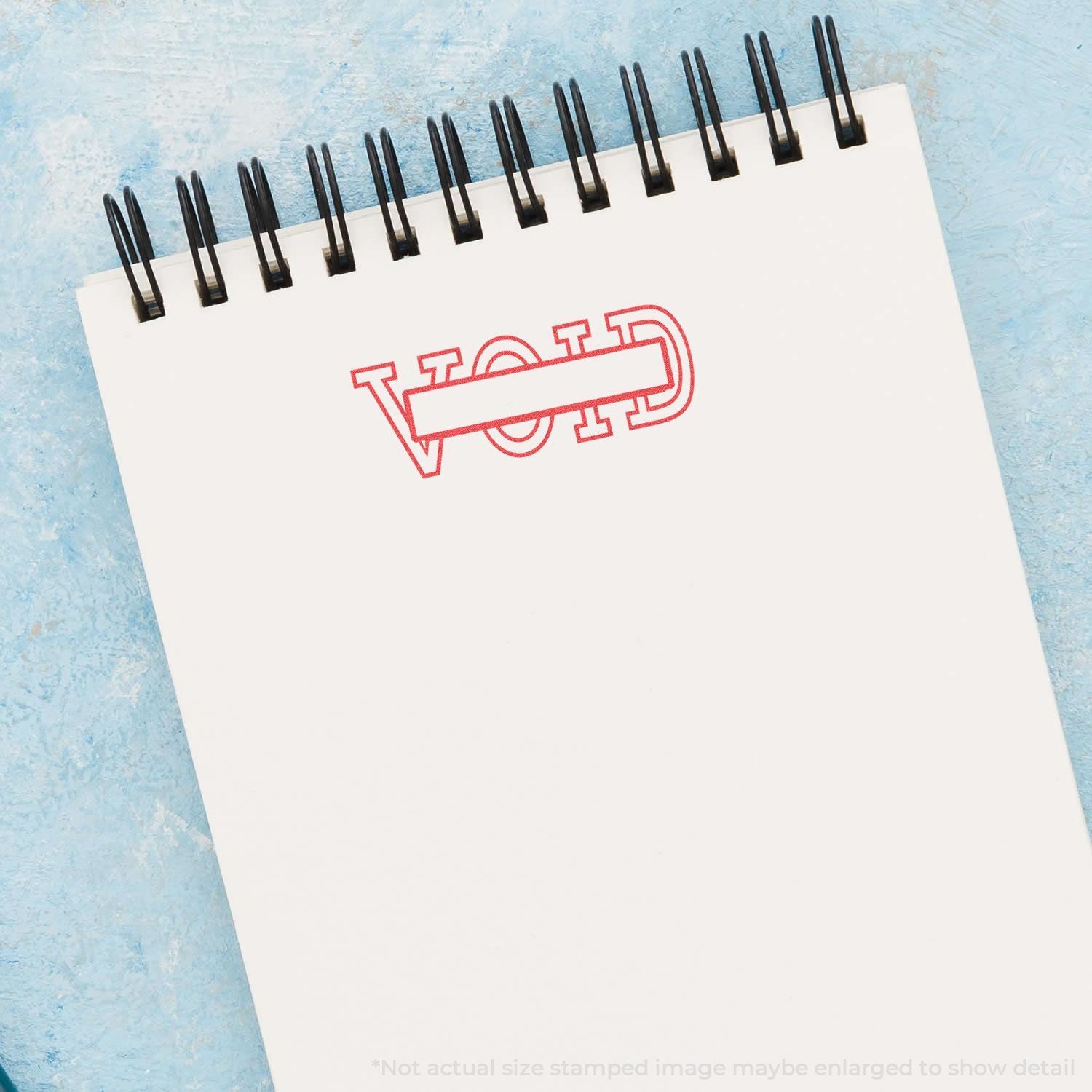 Branded white spiral notepad with red stamp-style logo, ideal for marketing stationery and promotional branding