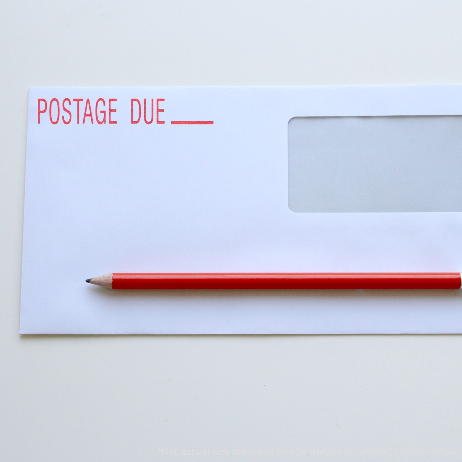 Postage due envelope concept with POSTAGE DUE stamp and pencil, highlighting unpaid shipping fees and letter delivery notices