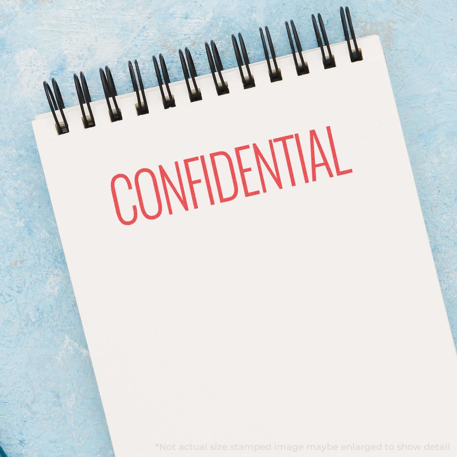 Confidential stamp on a spiral-bound document, conveying privacy and restricted access for secure business records.