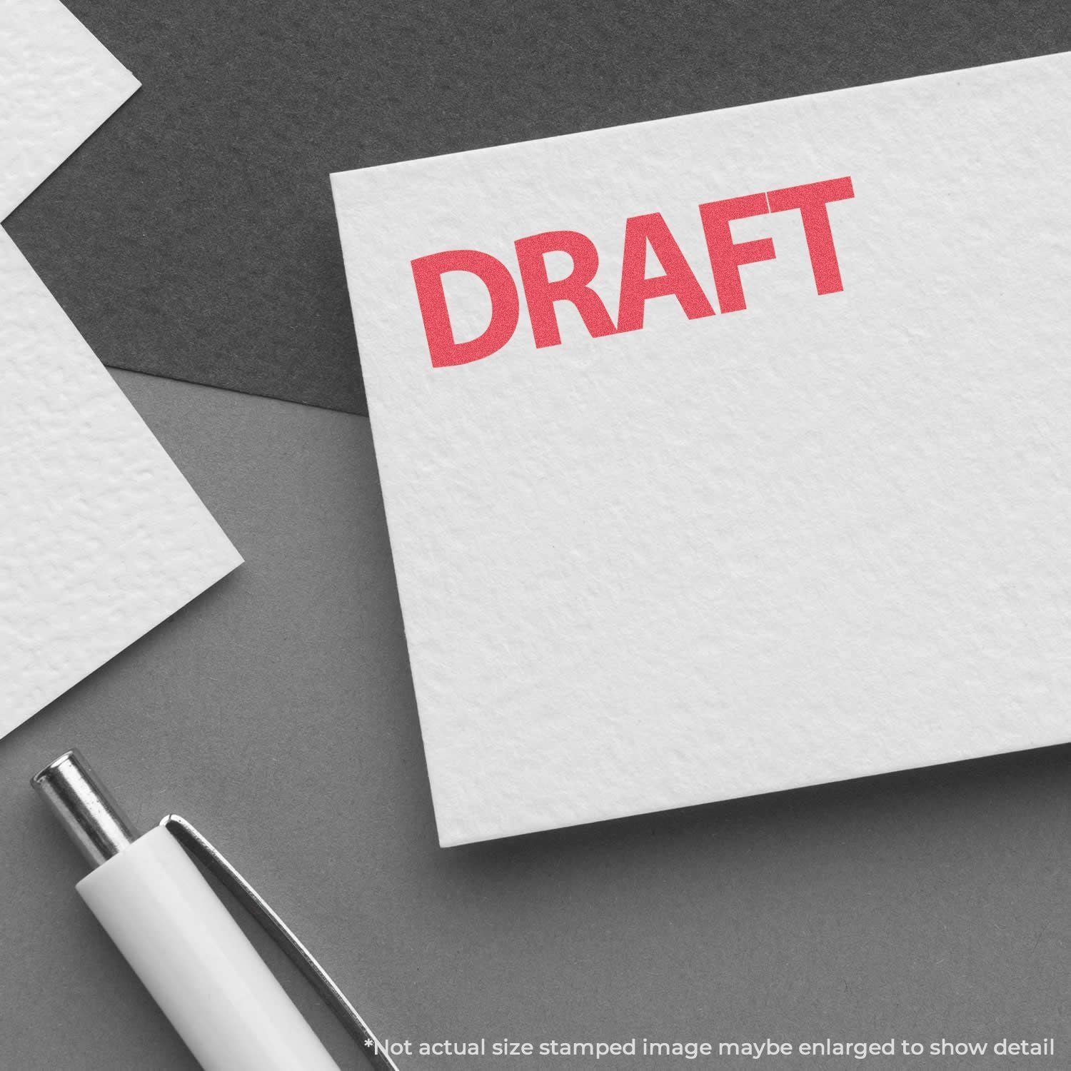Draft document card with red DRAFT text and pen on desk, representing writing review, editing, and revisions.