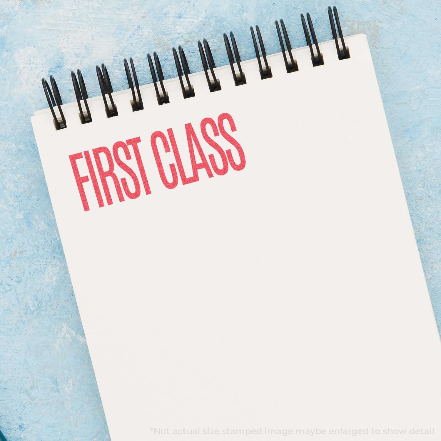 First Class calendar page with red lettering on a blue background, highlighting premium travel seating.