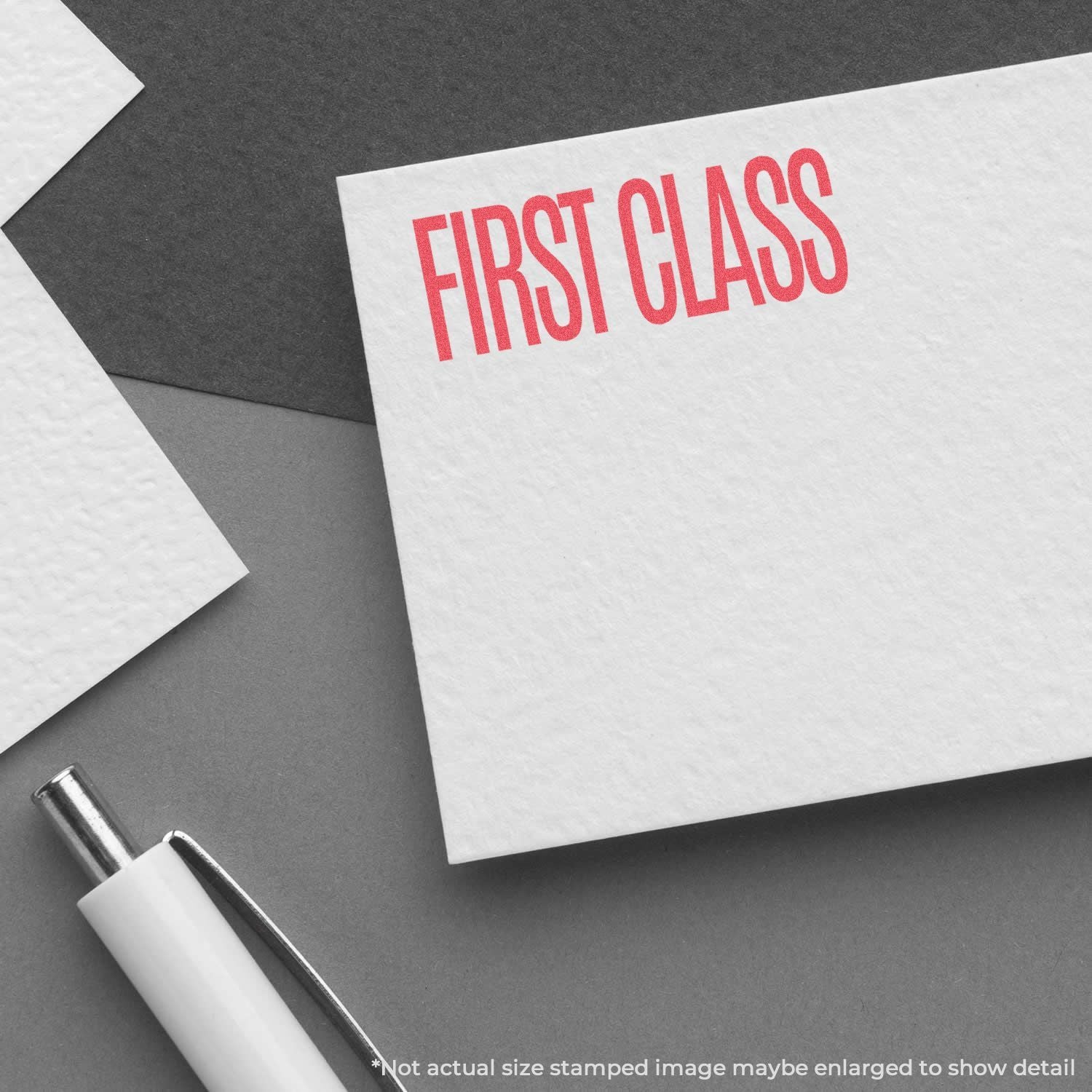 Close-up of First Class stamped mail on white stationery with pen, promoting premium shipping and express delivery services.