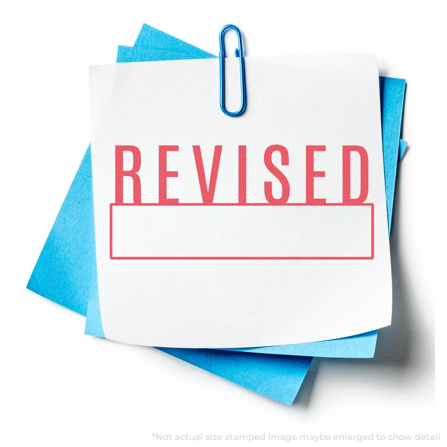 Revised document folder with binder clip showing REVISED label over blue paper files.