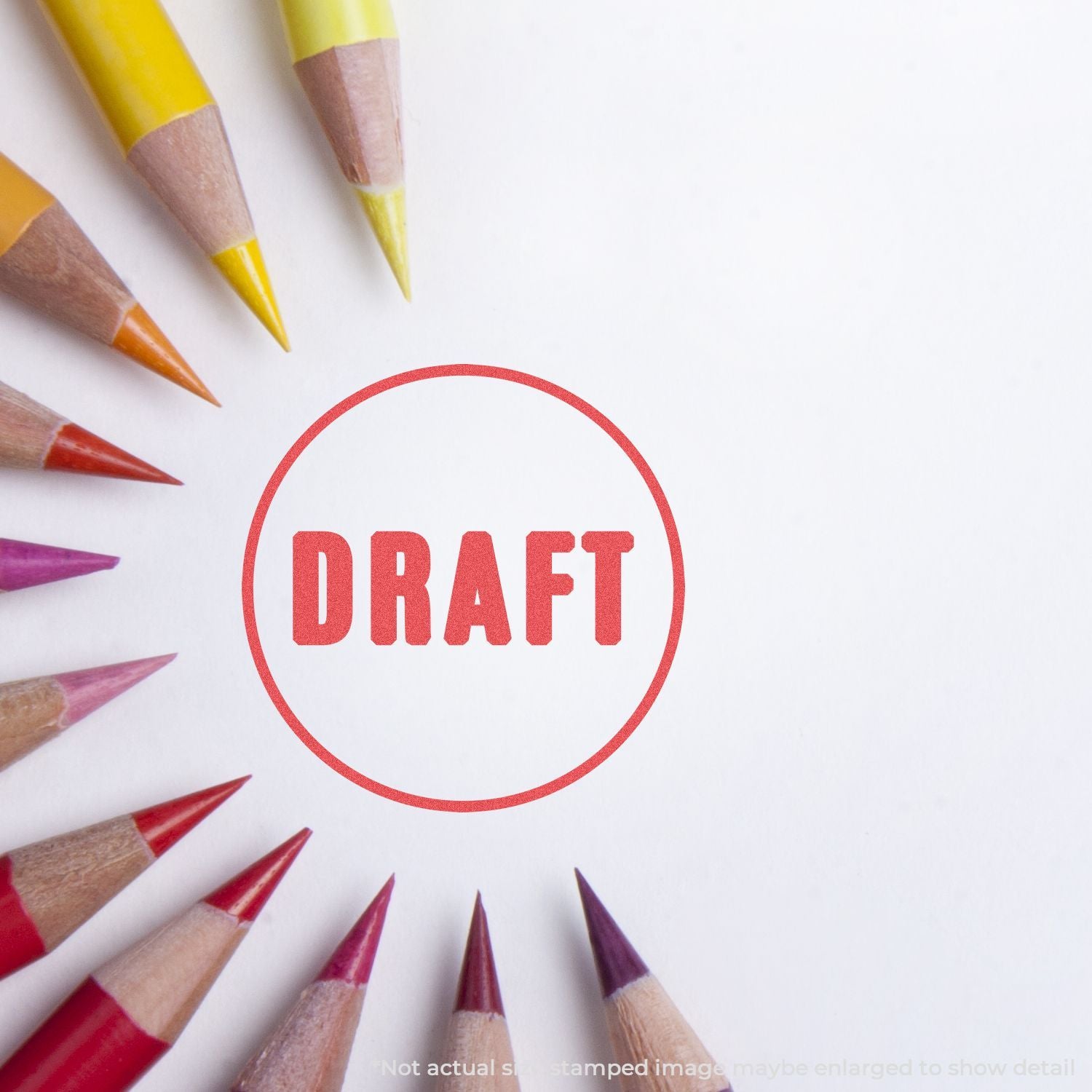 Red DRAFT stamp over scattered colored pencils, illustrating concept of drafting, sketching, and creative planning for art projects.