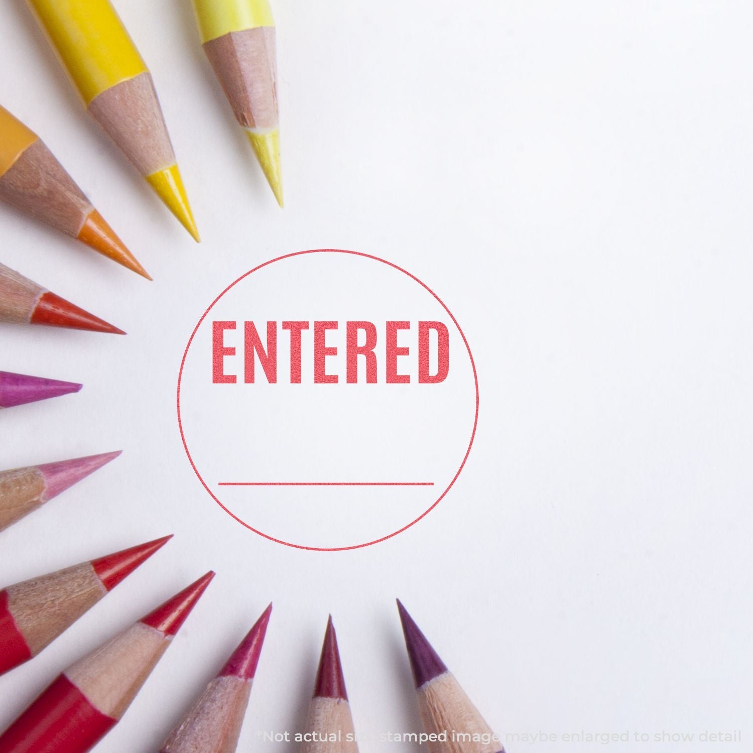 Colored pencils with the ENTERED stamp in a red circle, indicating registration or document entry.